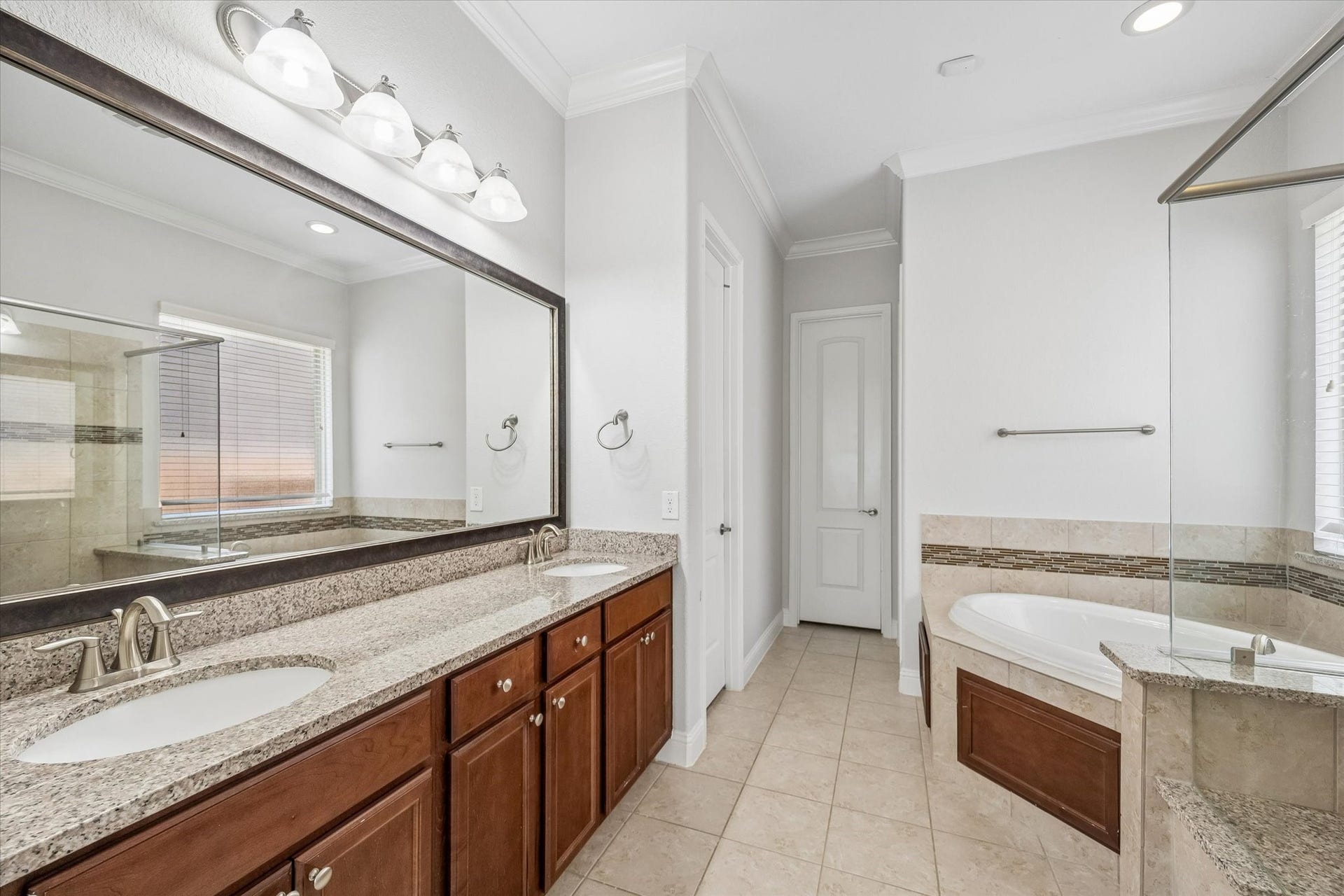11127 Glasgill Court, Richmond, TX 77407 Primary Bathroom with double vanities, soaking tub, and separate shower create a spa-like retreat