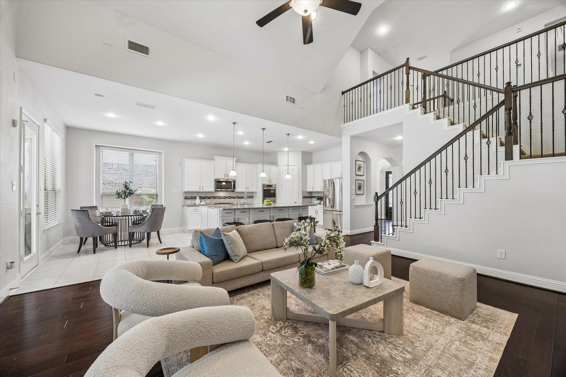 11127 Glasgill Court, Richmond, TX 77407 Elegant living room featuring soaring ceilings and rich wood flooring