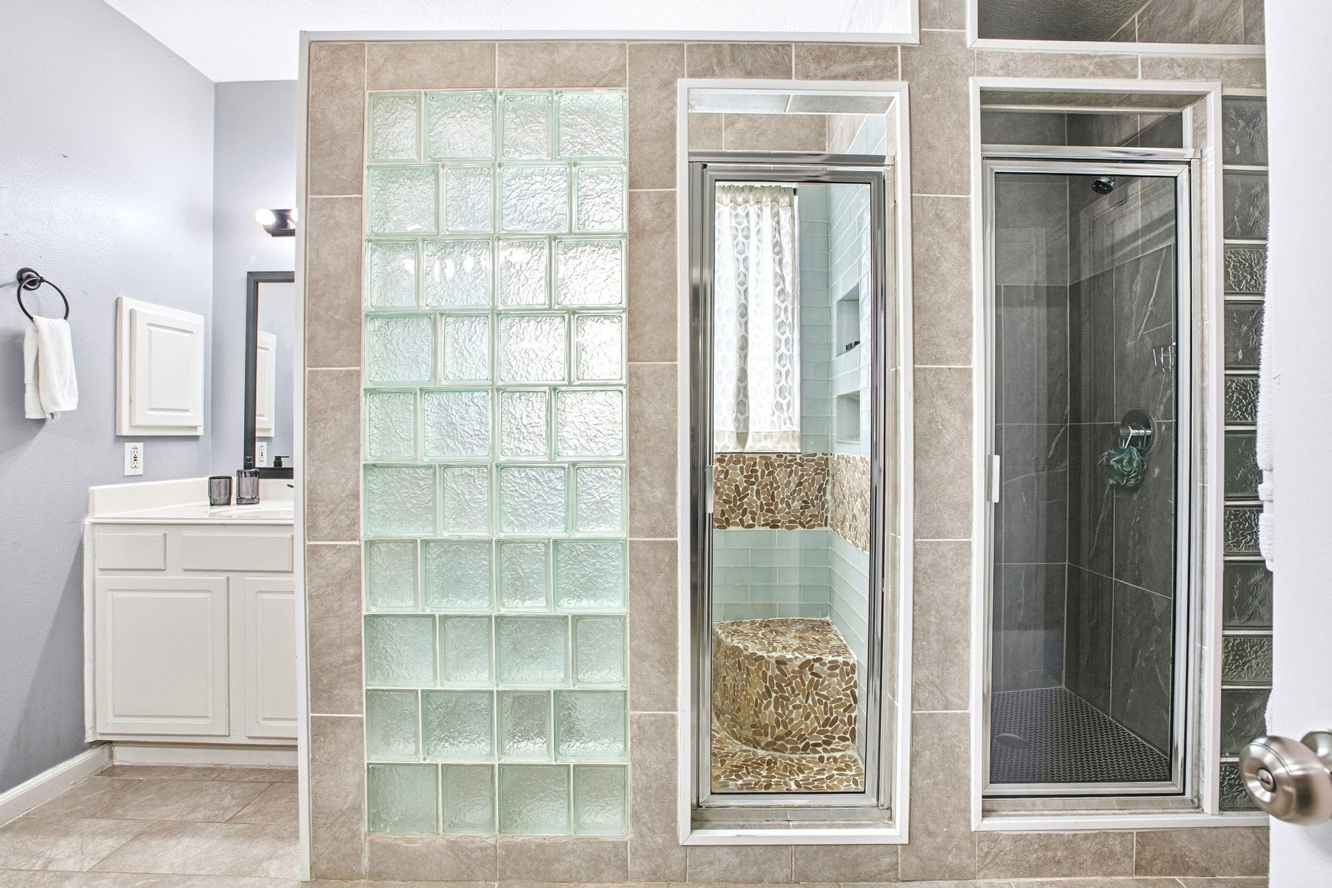 primary bathroom with his and her shower