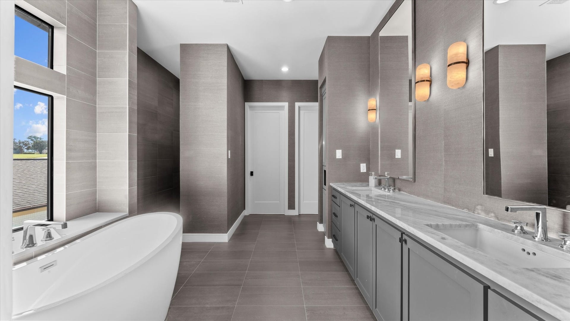 Primary bathroom en-suite with his and her closets.