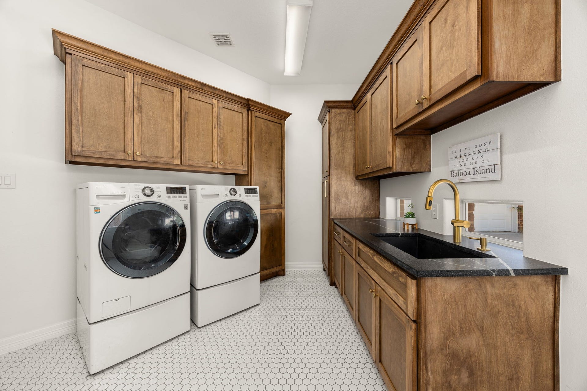 4719 Oxbow Circle W, Fulshear, TX 77441 Laundry Room With Built-In Cabinets, Sink, Countertops and a Side Entry Door/