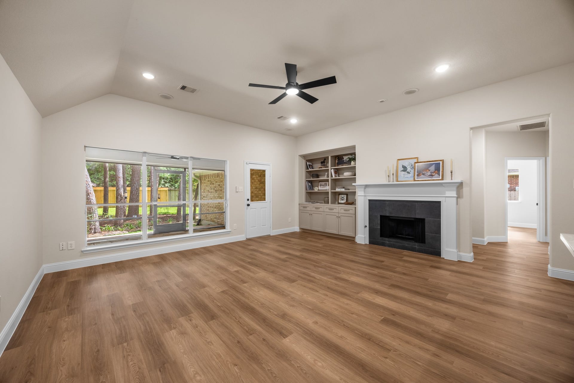 2 Gilded Crest Court, The Woodlands, TX 77382 Living room with new fireplace and custom built ins.