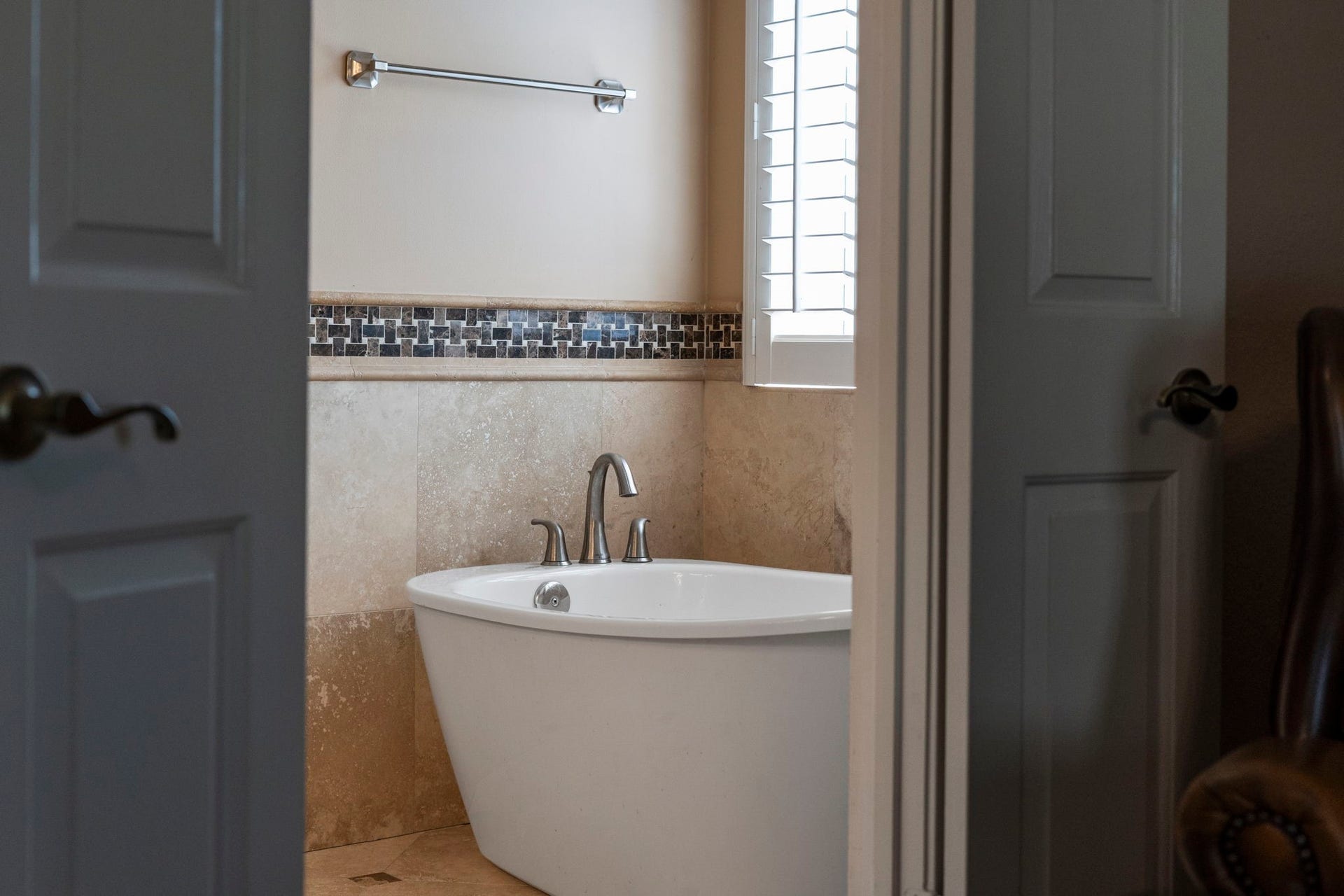 3407 Autumn Bend Drive, Sugar Land, TX 77479 Step inside the beautifully renovated owners bath, featuring a freestanding soaking tub that creates a serene retreat for relaxation.