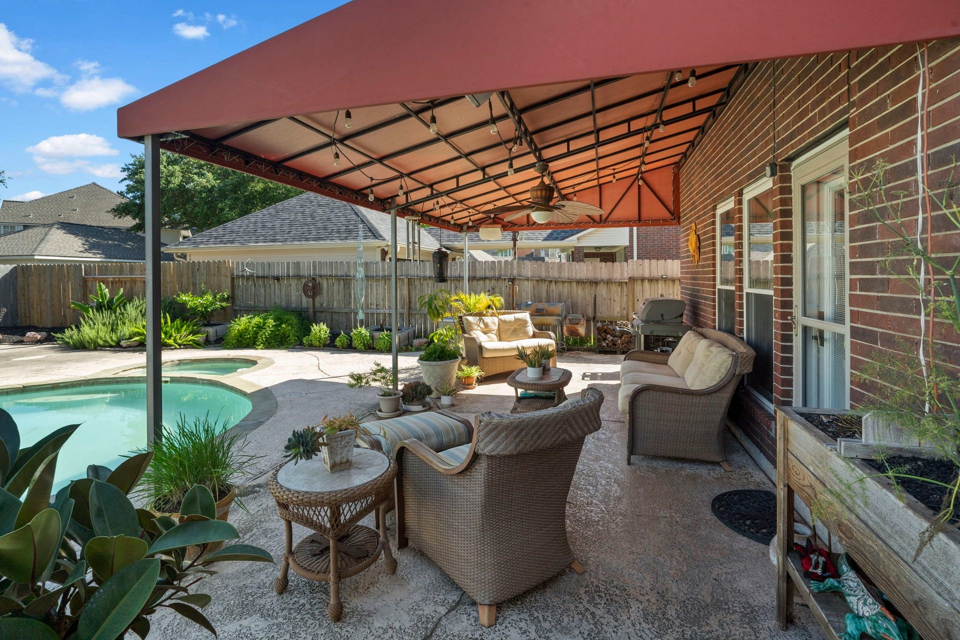 3407 Autumn Bend Drive, Sugar Land, TX 77479 An awning provides welcome shade and relief from the intense Texas sun, creating a comfortable space to relax outdoors even on the hottest summer days.