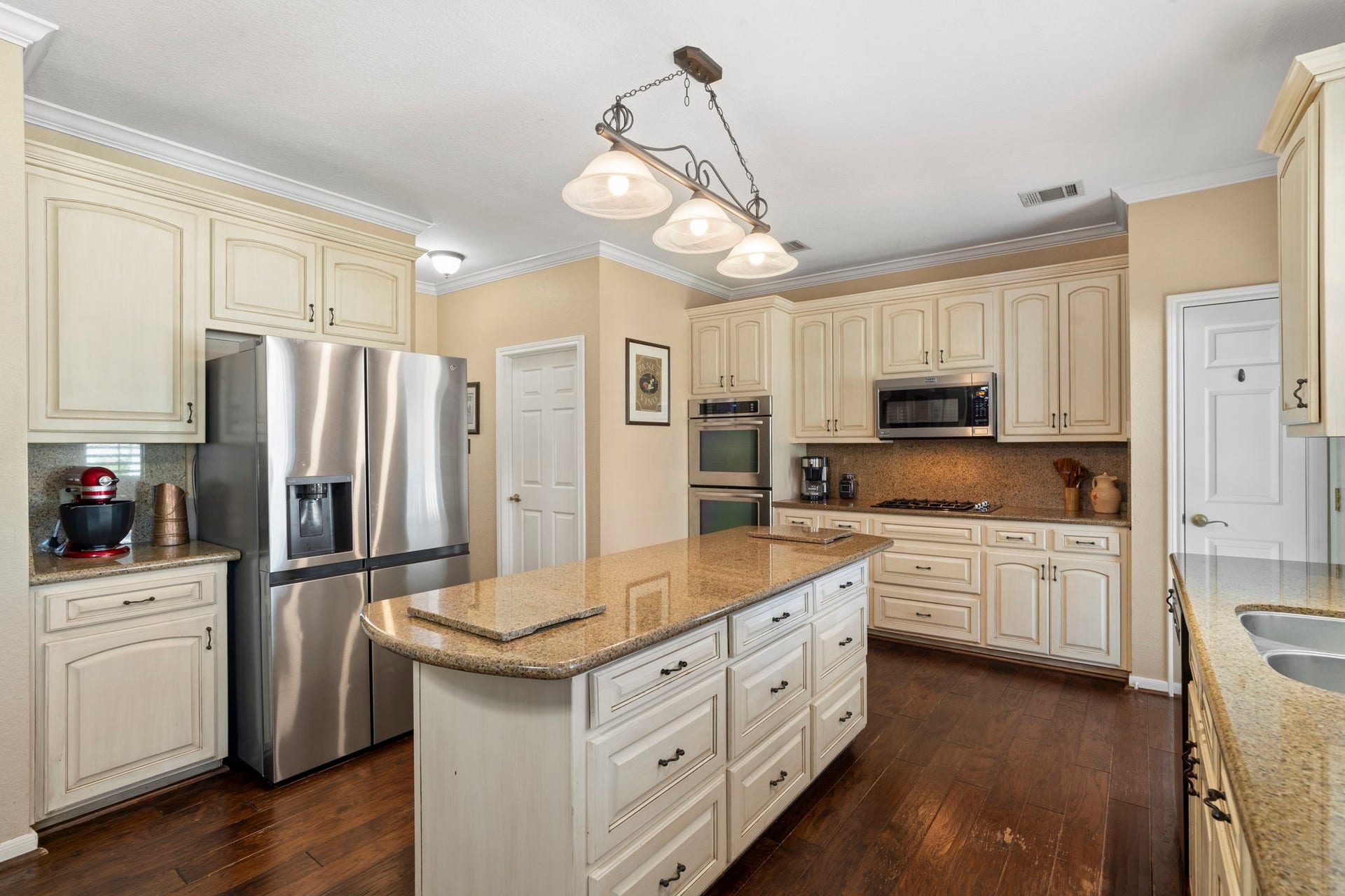 3407 Autumn Bend Drive, Sugar Land, TX 77479 Updated appliances include double convection ovens, a microwave, a gas cooktop, and a built-in dishwasher.