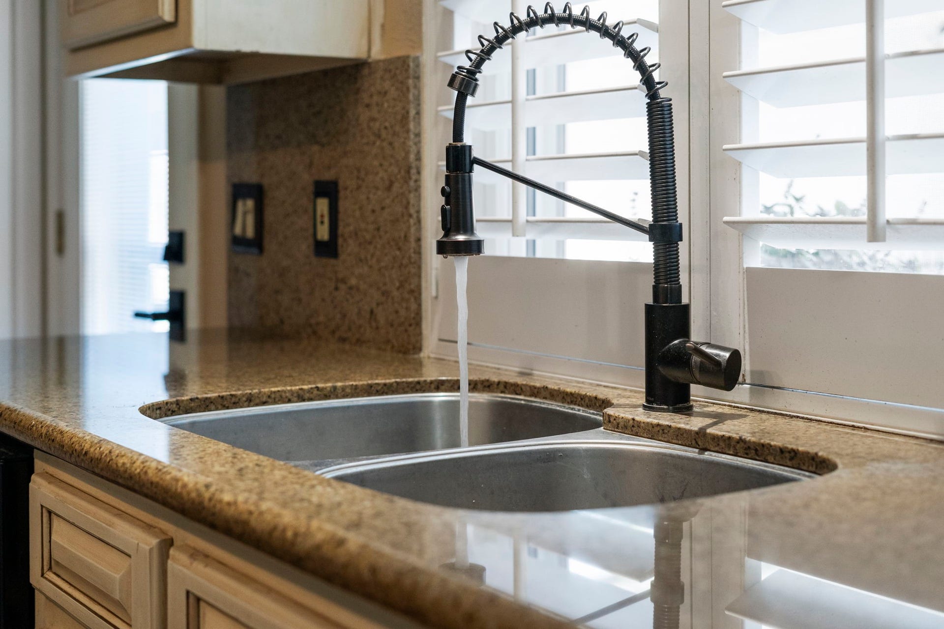 3407 Autumn Bend Drive, Sugar Land, TX 77479 Double-basin stainless steel sink with a restaurant-style pull-down faucet, offering durability for everyday cooking and cleanup.