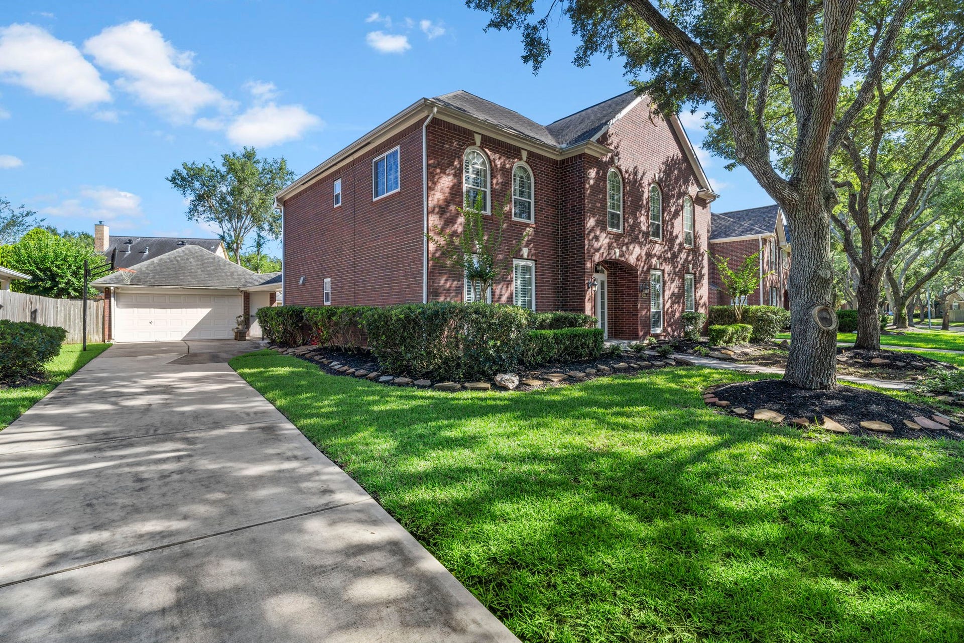 3407 Autumn Bend Drive, Sugar Land, TX 77479 A long driveway leads to a detached two-car garage, offering ample off-street parking and plenty of space for recreationperfect for basketball, bike riding, or kids playing safely right at home.