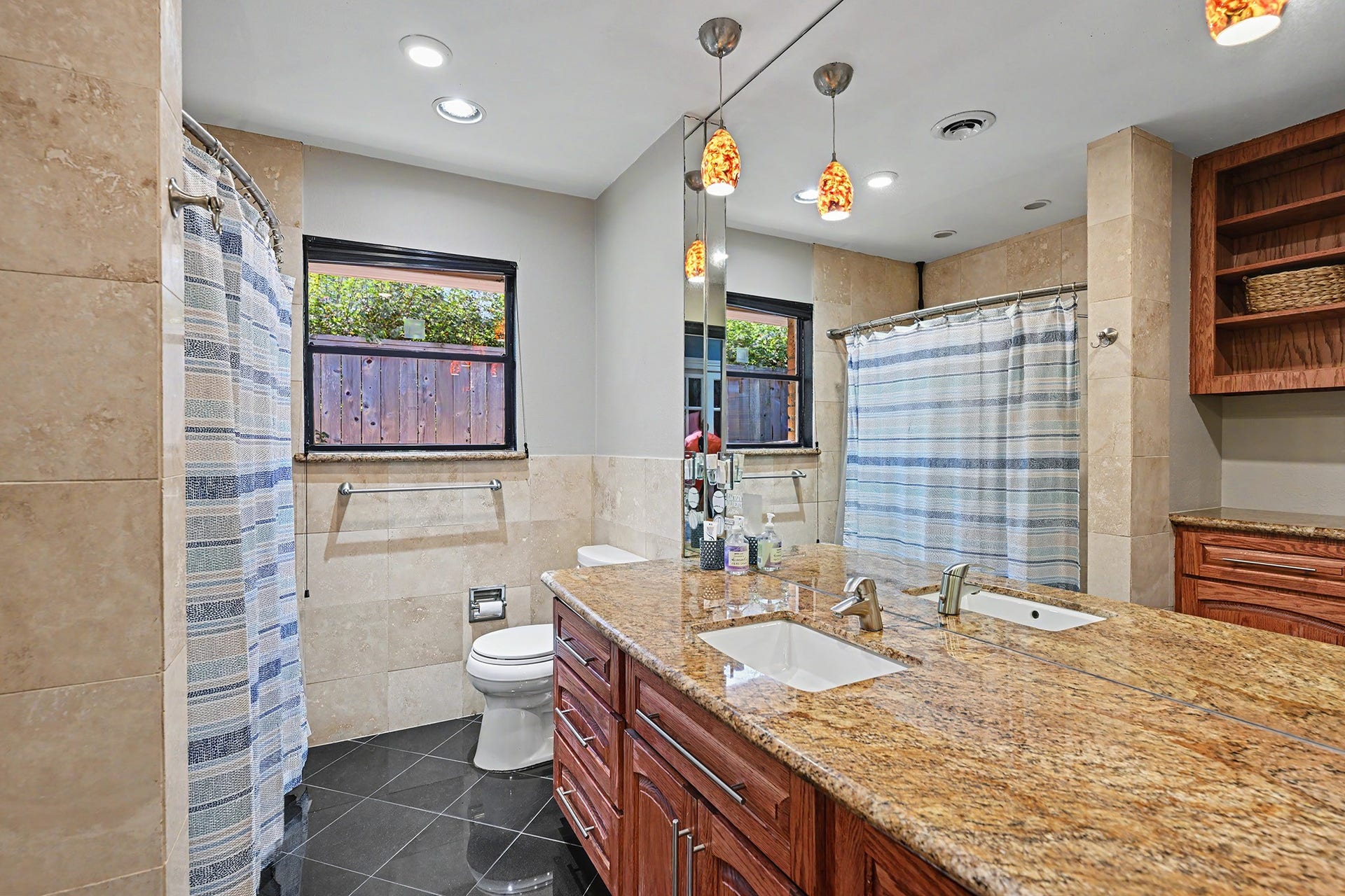 The hall bath with a tub/shower and granite counter.  Note all the storage space.