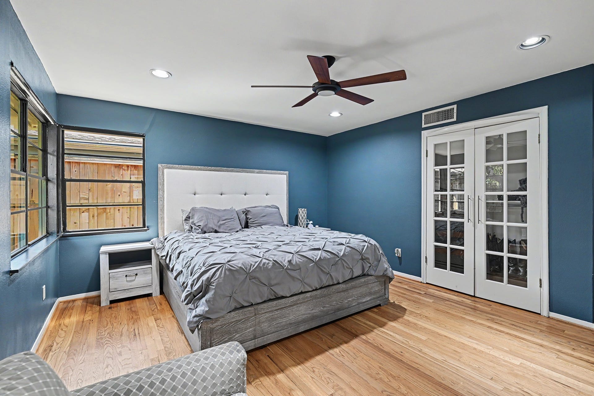 Wood flooring continue into the bedroom wing.  The primary has great views of the back yard.
