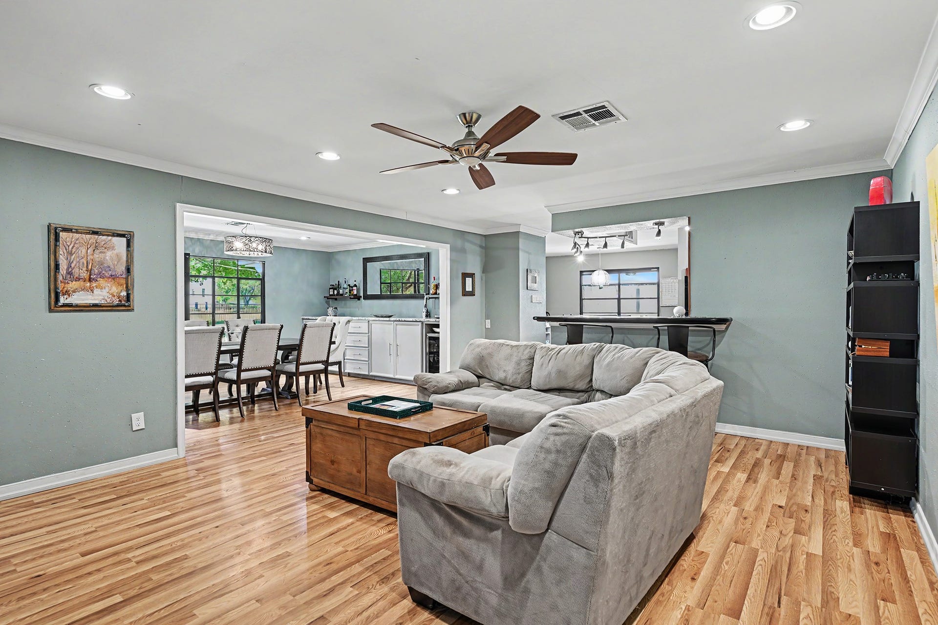 Gleaming wood floor in the family living area with access to the kitchen and dining room.