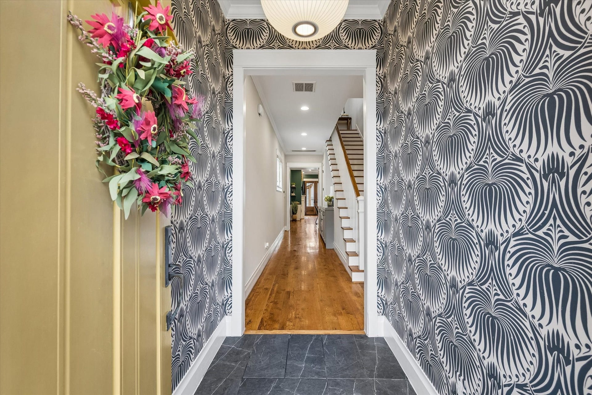 438 W 28th Street, Houston, TX 77008 First impressions are everything, and this entry knows how to make one! Imported designer wallpaper, stylish Herman Miller lighting and updated tile flooring create a welcoming entrance with plenty of personality and a hint of what's to come.