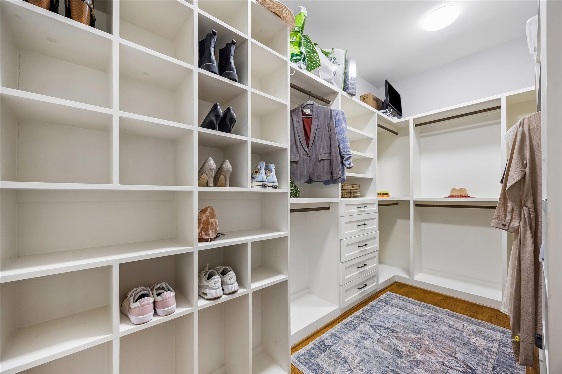 438 W 28th Street, Houston, TX 77008 Closet space you'll actually get excited about! One of two custom walk-in closets in the primary suite, this spacious closet features shelves galore, built-in drawers and plenty of hanging space to keep everything from your favorite shoes to everyday essentials neatly organized.