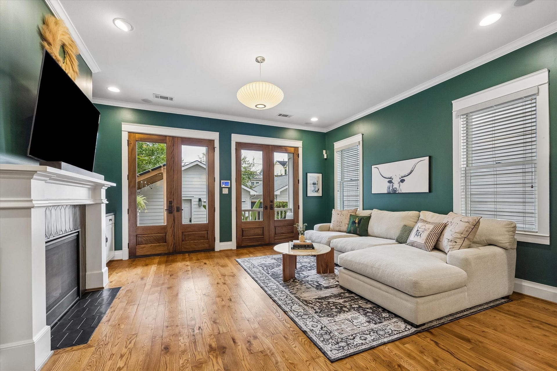 438 W 28th Street, Houston, TX 77008 This welcoming family room is ready for everything from quiet evenings by the gas log fireplace to lively get togethers with friends and family. Beautiful wood floors, rich designer paint and custom built-ins add warmth and character, while two sets of French doors invite you outside to enjoy the back porch, yard and pool.