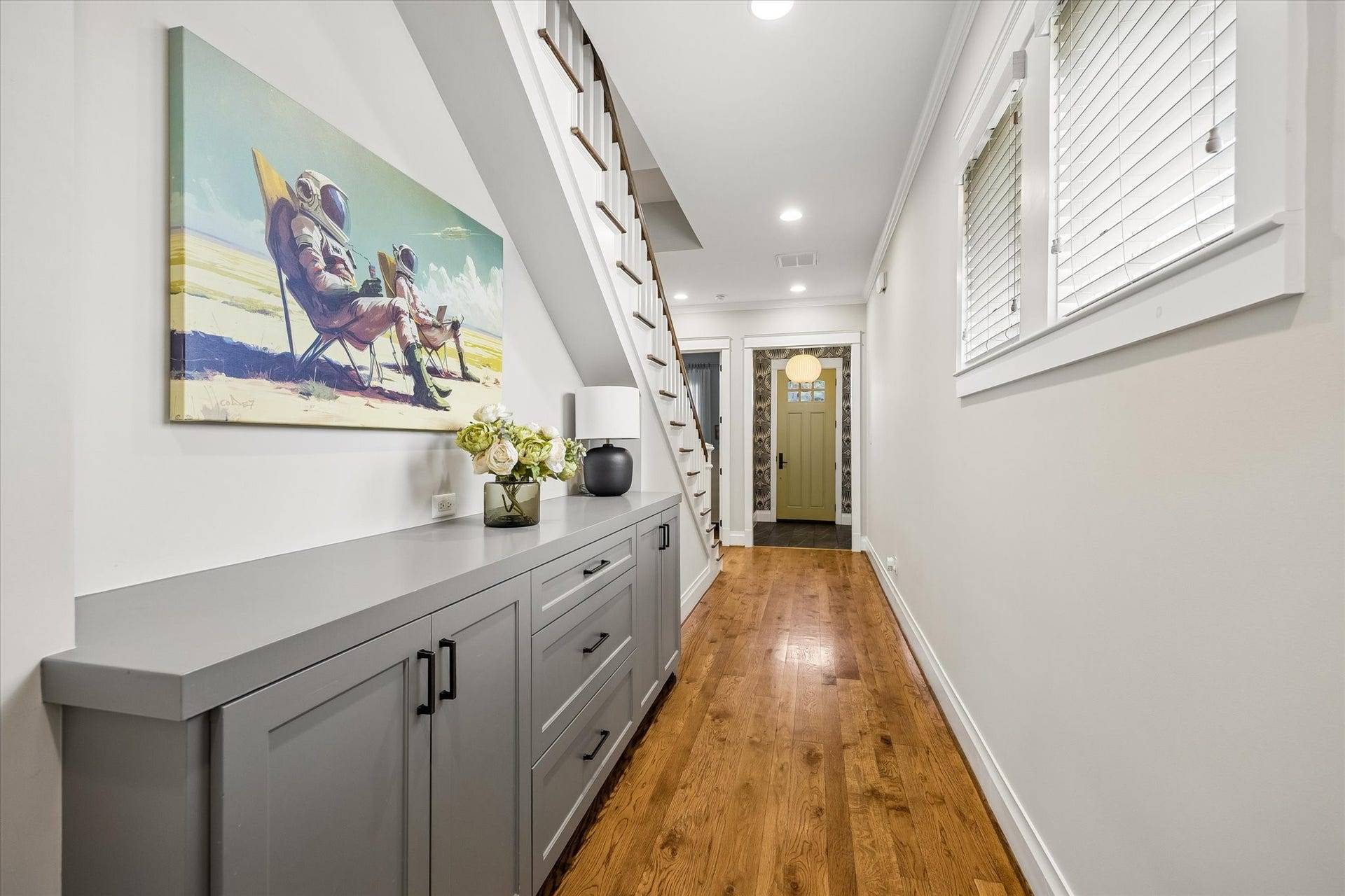 438 W 28th Street, Houston, TX 77008 Beautiful details and smart storage make everyday living a little easier! This hallway features custom built-in storage with plenty of room to keep things organized, while rich hardwood floors, crisp millwork and natural light add warmth and charm.