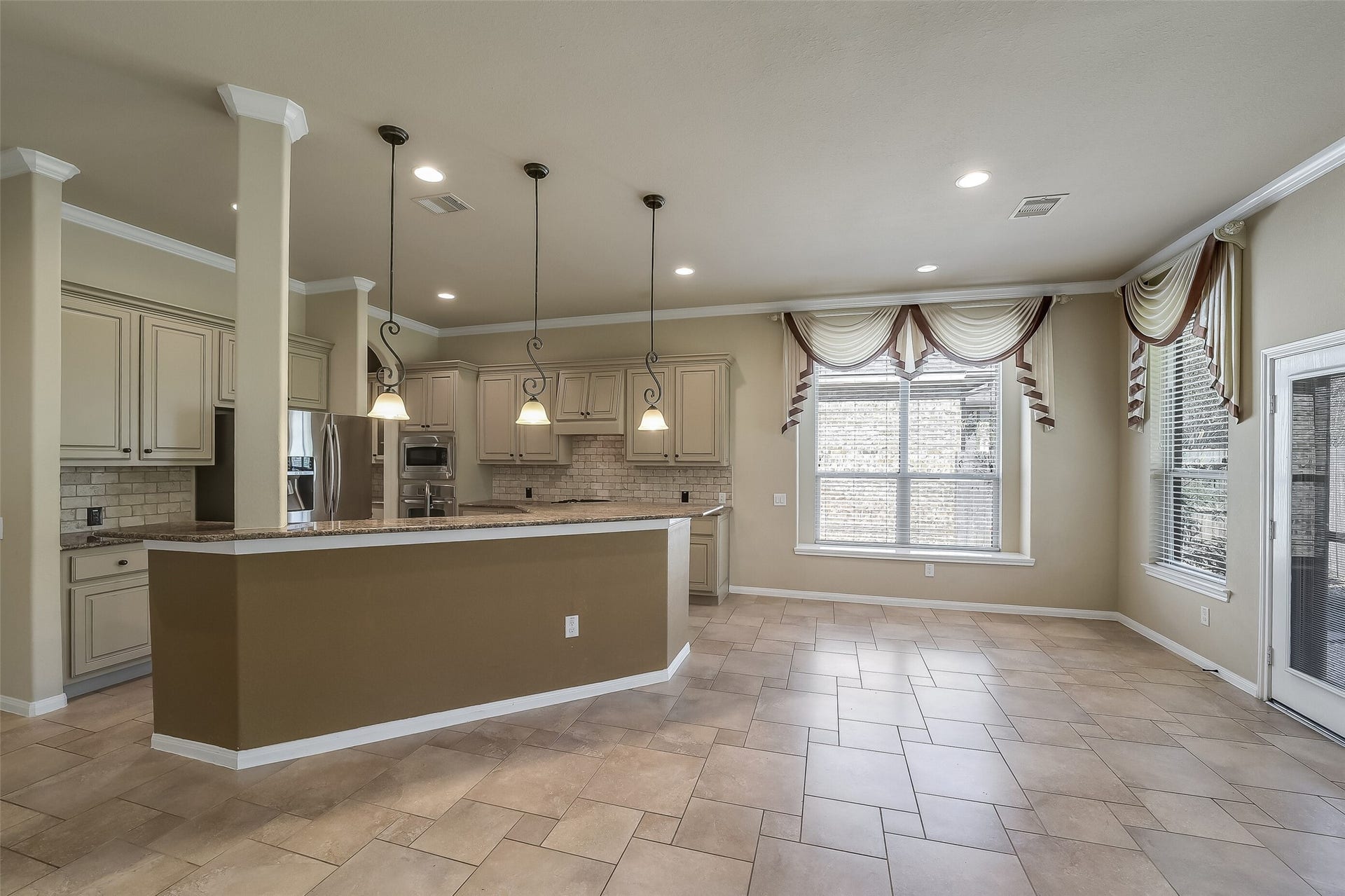 16706 Curio Gray Trail, Cypress, TX 77433 The long breakfast bar overlooks the family room. Notice the beautiful pattern in the extended tile flooring. This home is even more beautiful in person.