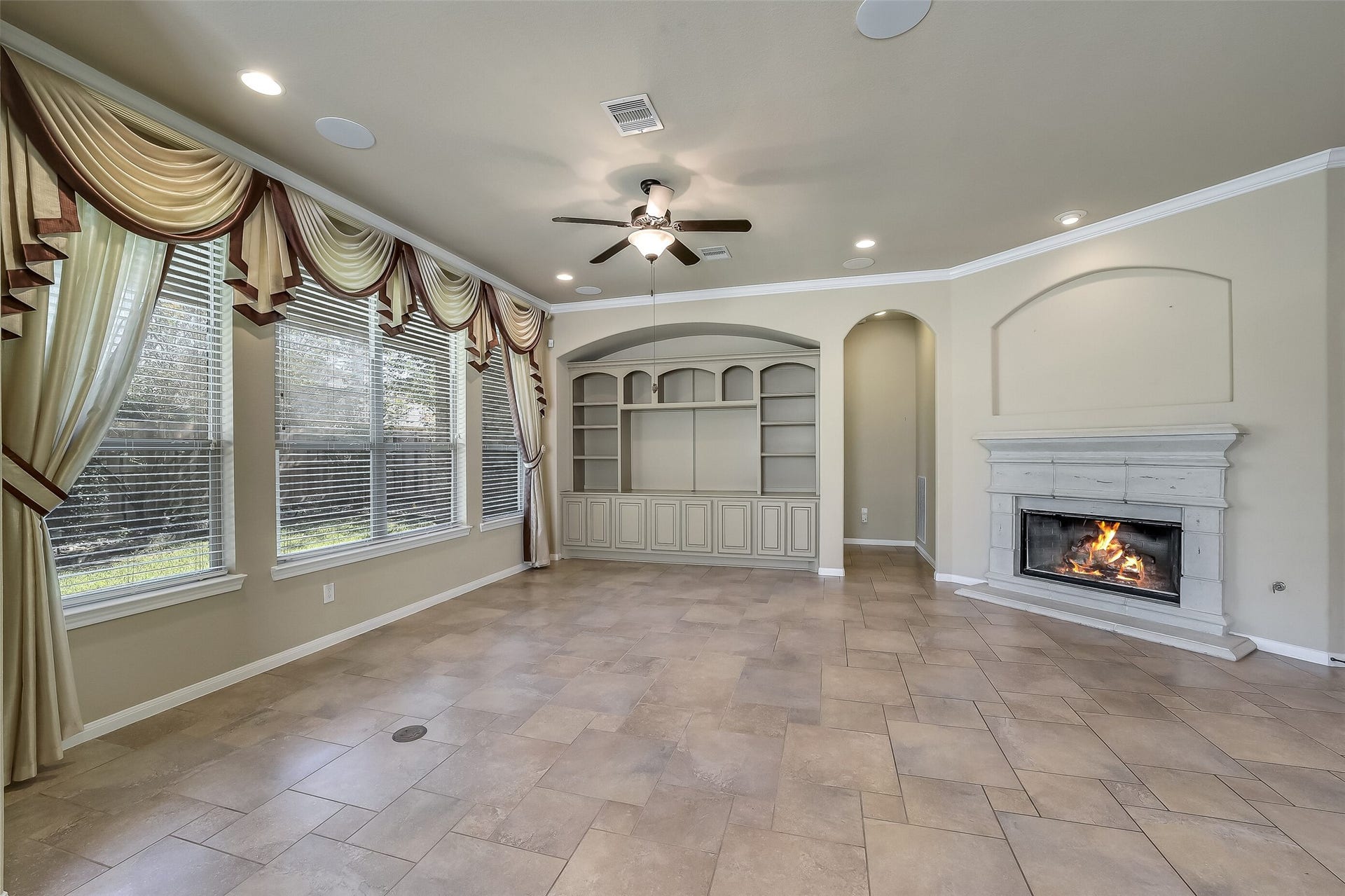 16706 Curio Gray Trail, Cypress, TX 77433 Custom built-in book shelves and cabinets and a nice sized space for TV niche. The family room offers a corner gas log fireplace and great big windows overlooking the landscaped back yard.