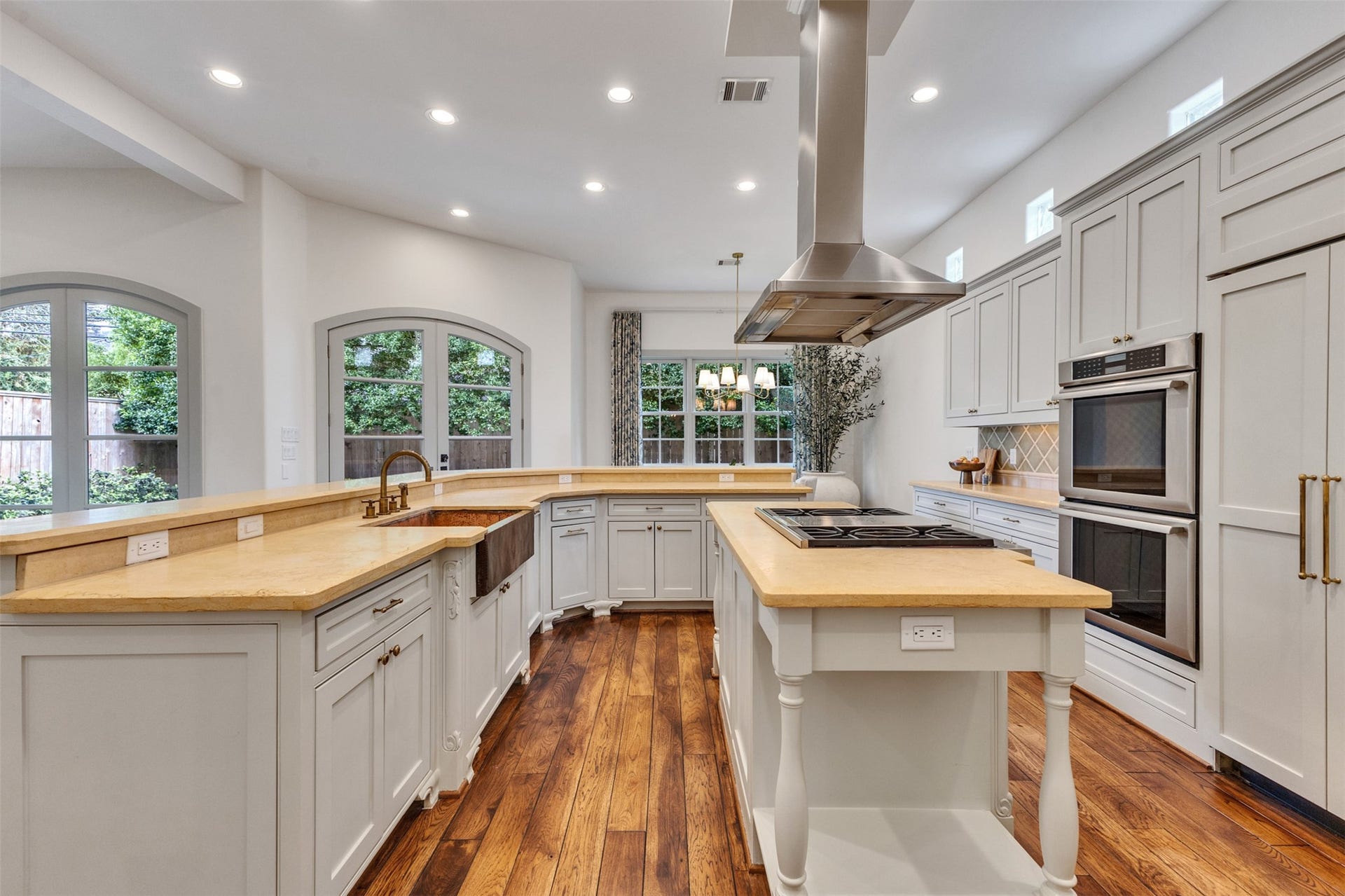 2721 Cason Street, West University Place, TX 77005 Kitchen with custom cabinetry, double ovens, a big pantry and view of all that is going on in the living and breakfast rooms. A copper sink and designer fixtures add warmth