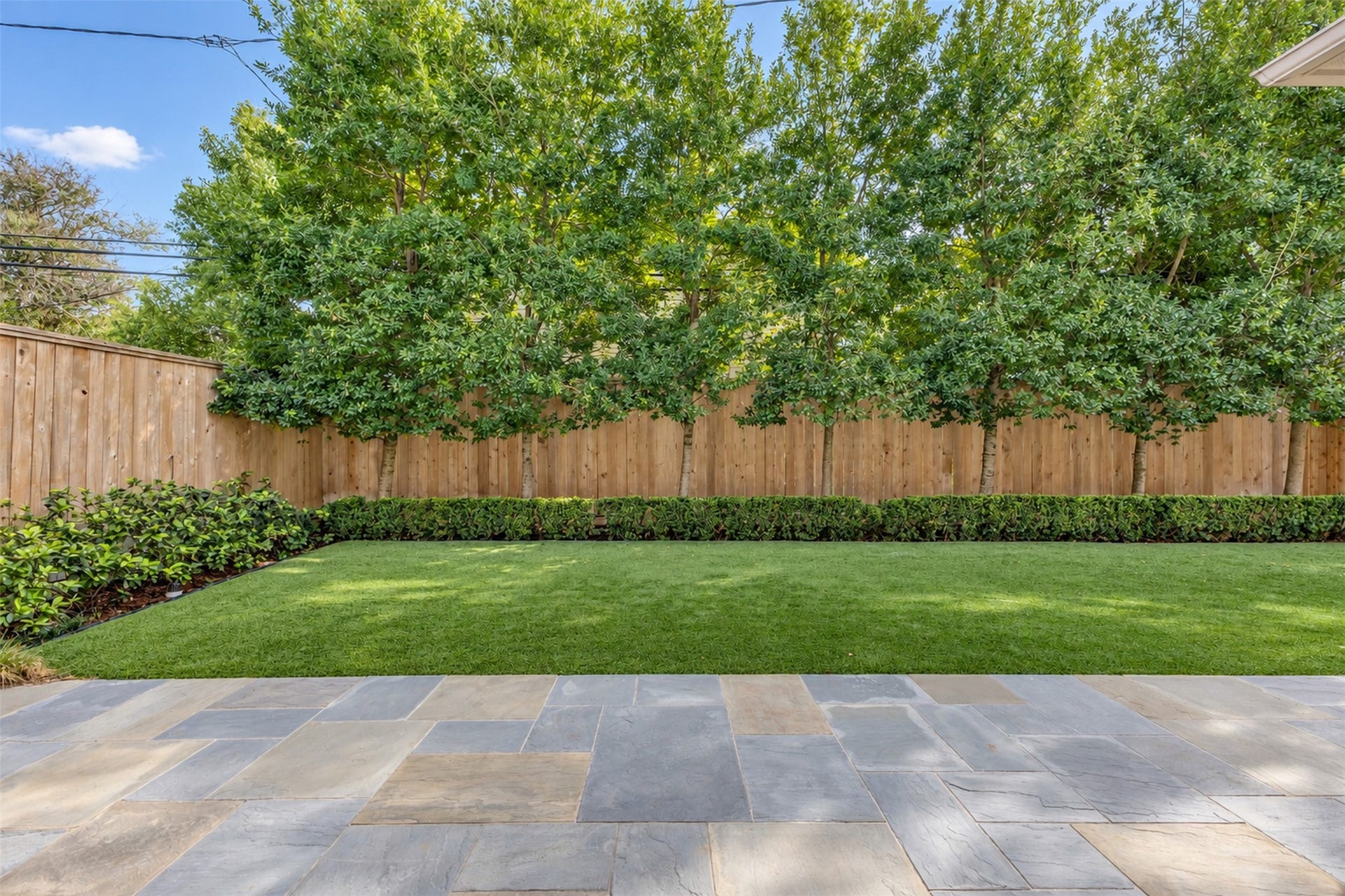 2721 Cason Street, West University Place, TX 77005 Thompson+Hanson designed the landscaping including this row of holly trees providing privacy