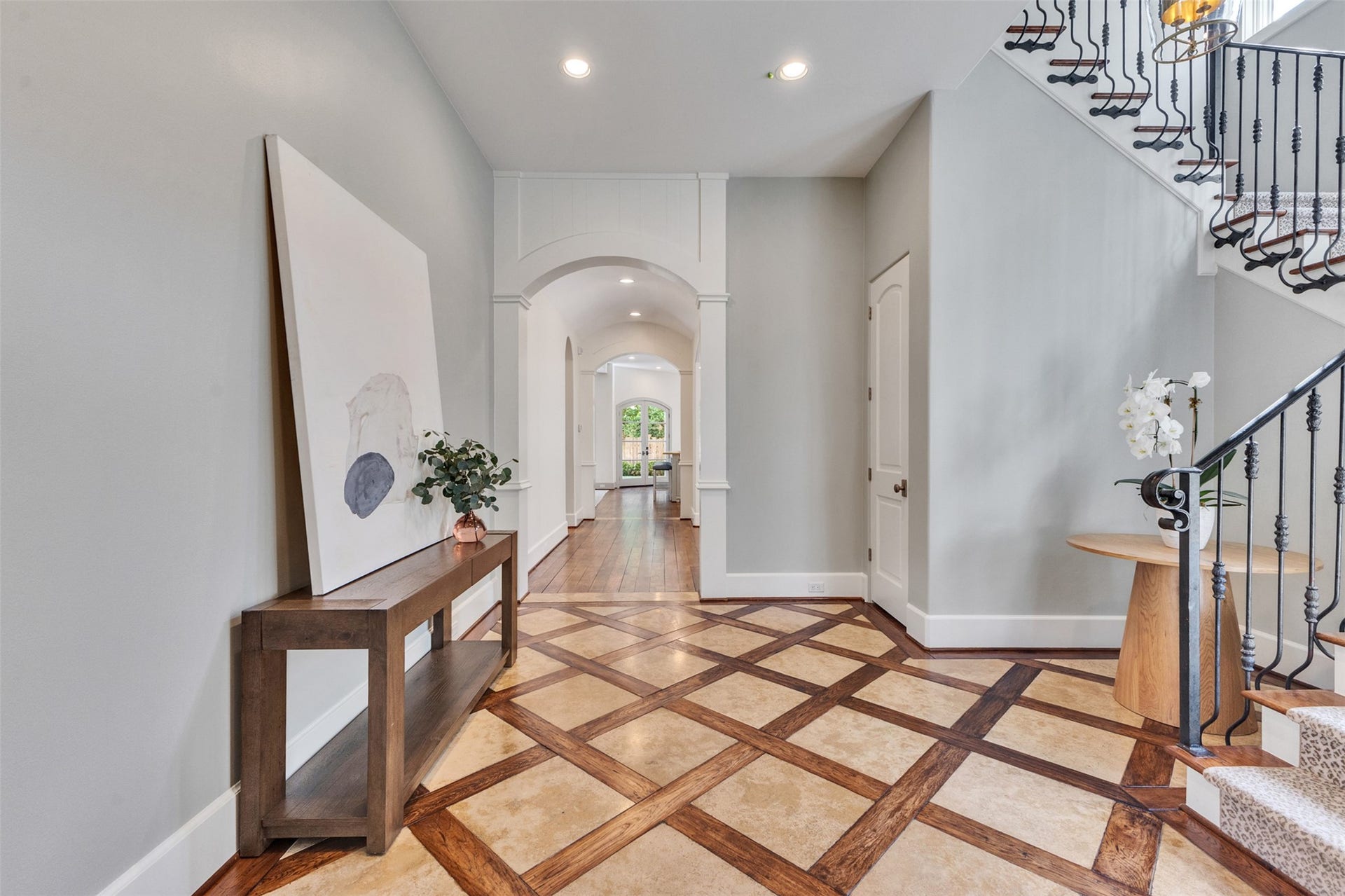 2721 Cason Street, West University Place, TX 77005 Elegant and spacious entry with inlaid flooring, custom ironwork, and a large under stair closet