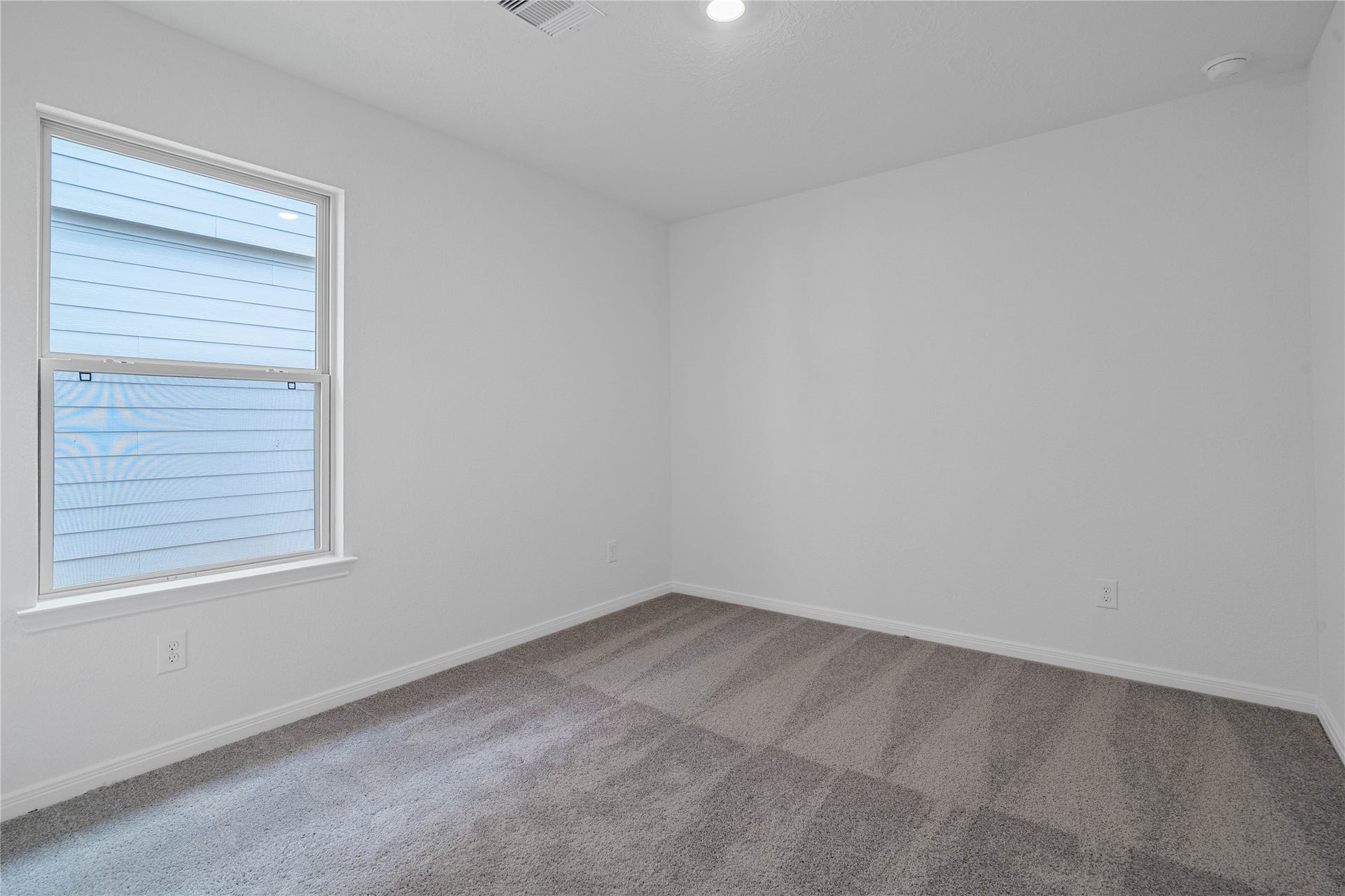 1710 Livadero Lane, Fresno, TX 77545 Light-filled secondary bedroom complete with cozy carpet flooring, ample closet space, and a large window.