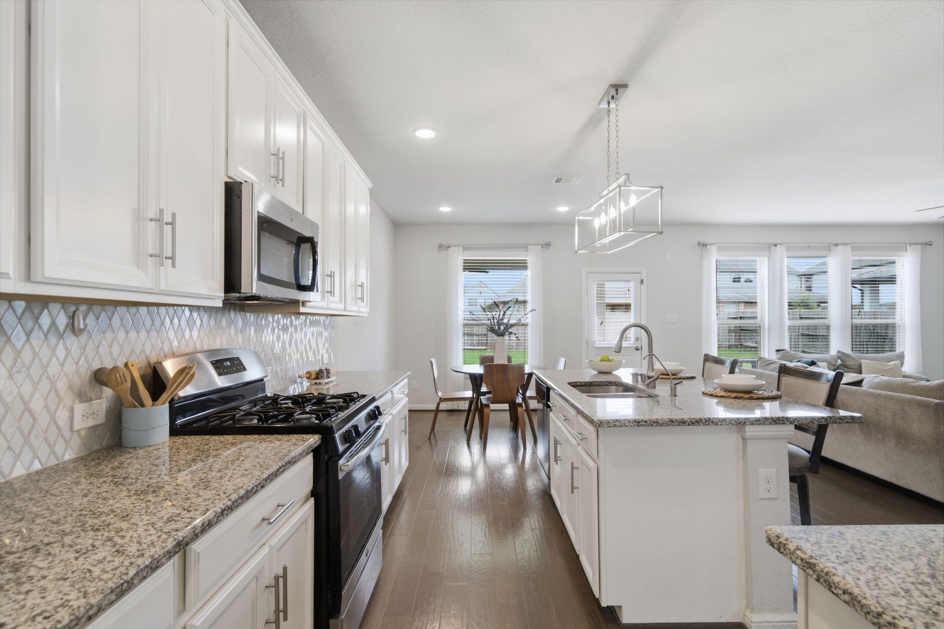 Gourmet kitchen with quartz countertops, a spacious island and stainless steel appliances.