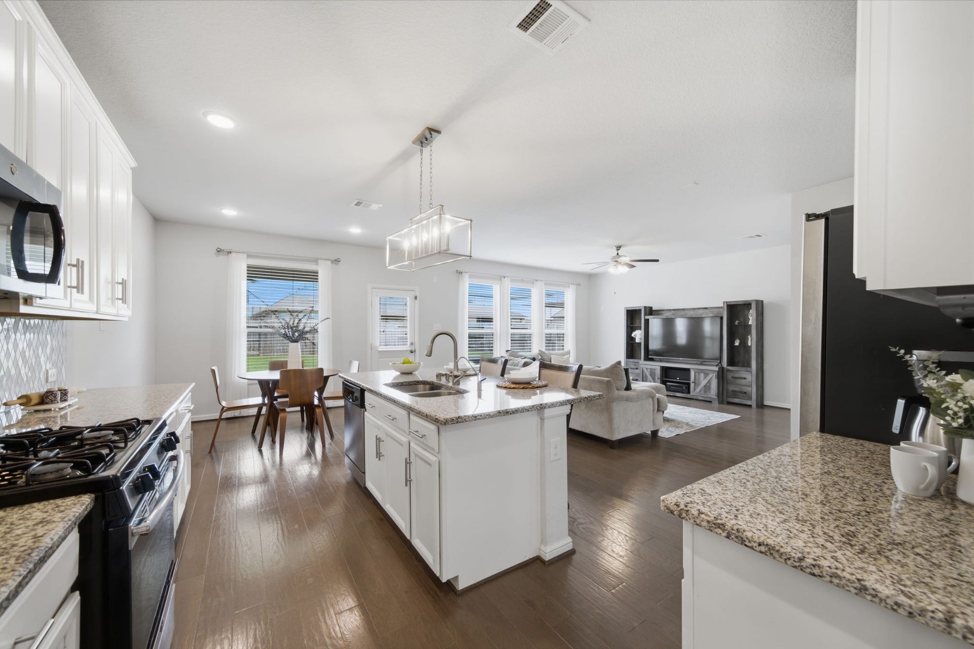 Open-concept floorplan featuring a modern kitchen overlooking the living room which helps keep everyone stay connected.