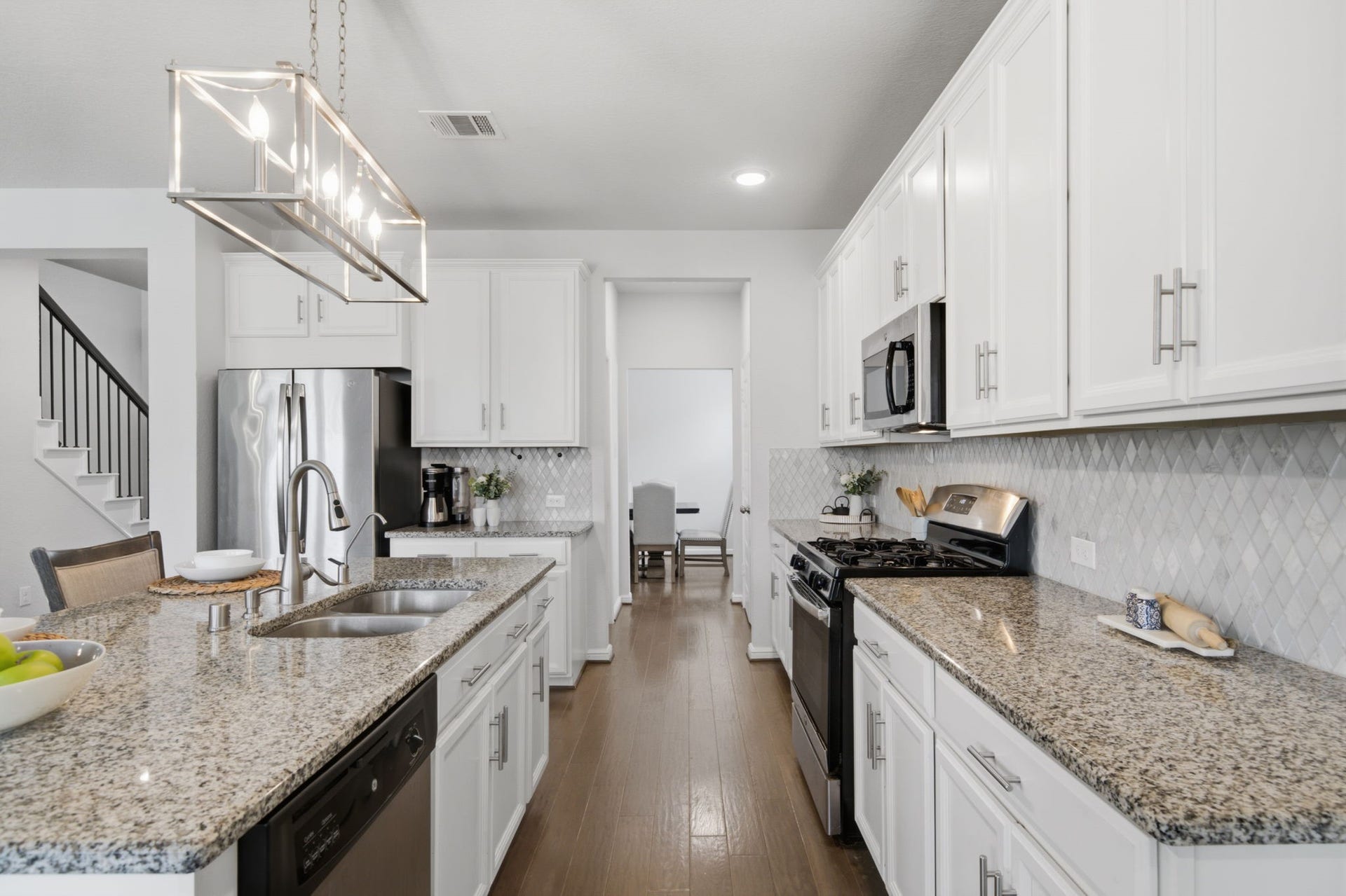 The kitchen features a kitchen island with a breakfast bar, which is great for perfect seating.