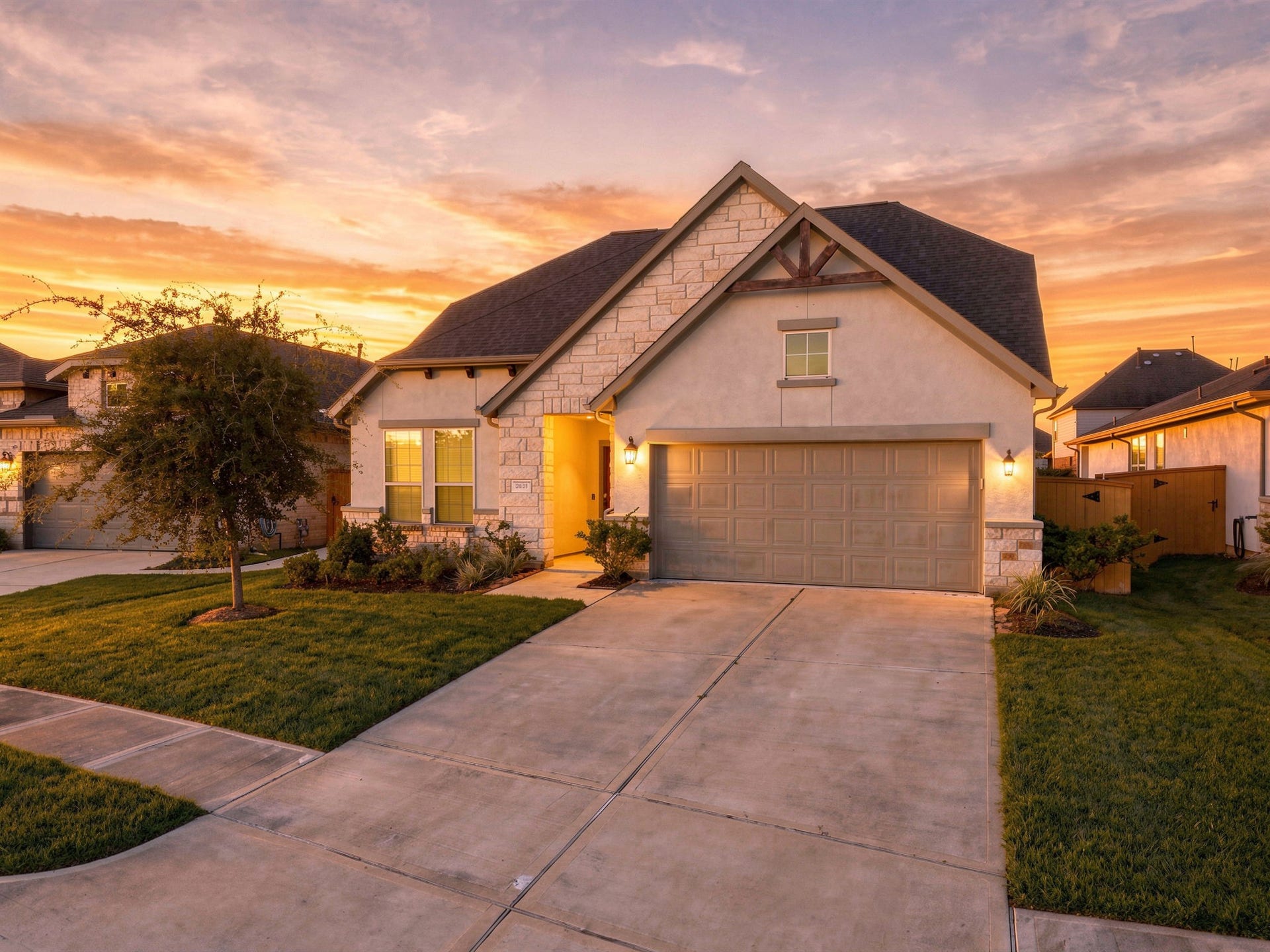 Charming single-story home with a welcoming facade, featuring a spacious driveway and a beautifully maintained lawn.