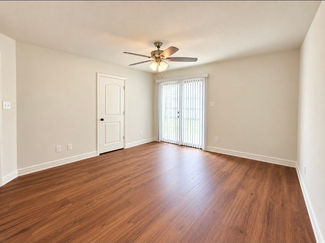 12221 Seacrest Lane, Texas City, TX 77568 Primary bedroom with brand-new luxury vinyl plank flooring with private sliding glass door into the backyard.