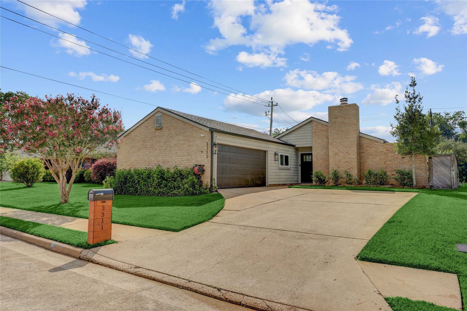 3311 Carmel Valley Drive, Missouri City, TX 77459 Beautifully maintained brick exterior with mature landscaping, an oversized driveway and inviting curb appeal. The updated garage door and clean architectural lines create a welcoming first impression.