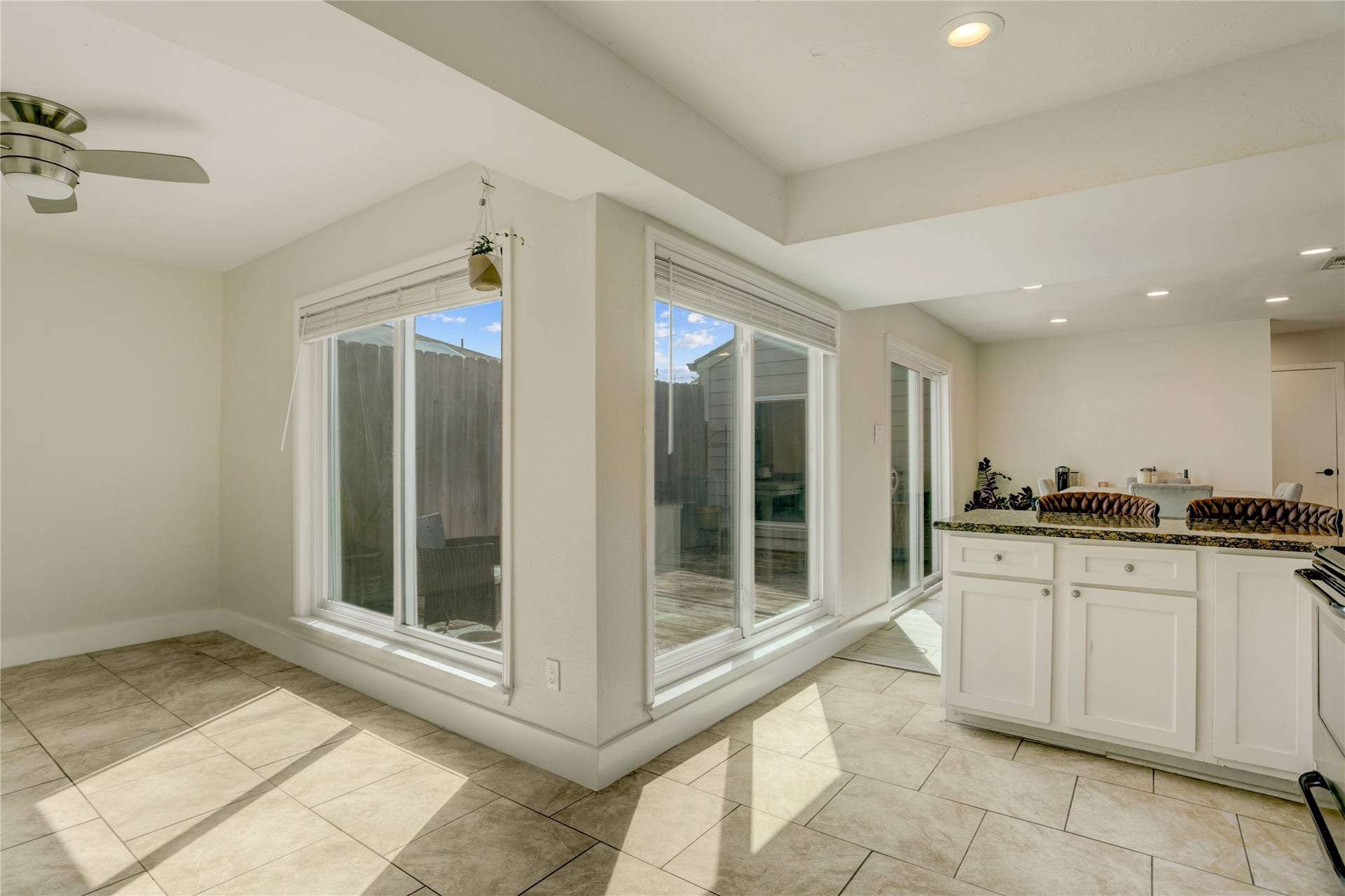 3311 Carmel Valley Drive, Missouri City, TX 77459 Sun filled breakfast area and kitchen showcase walls of windows, bringing in abundant light and offering seamless views of the private outdoor living space. Recessed lighting and new ceiling fans complete this inviting kitchen area.