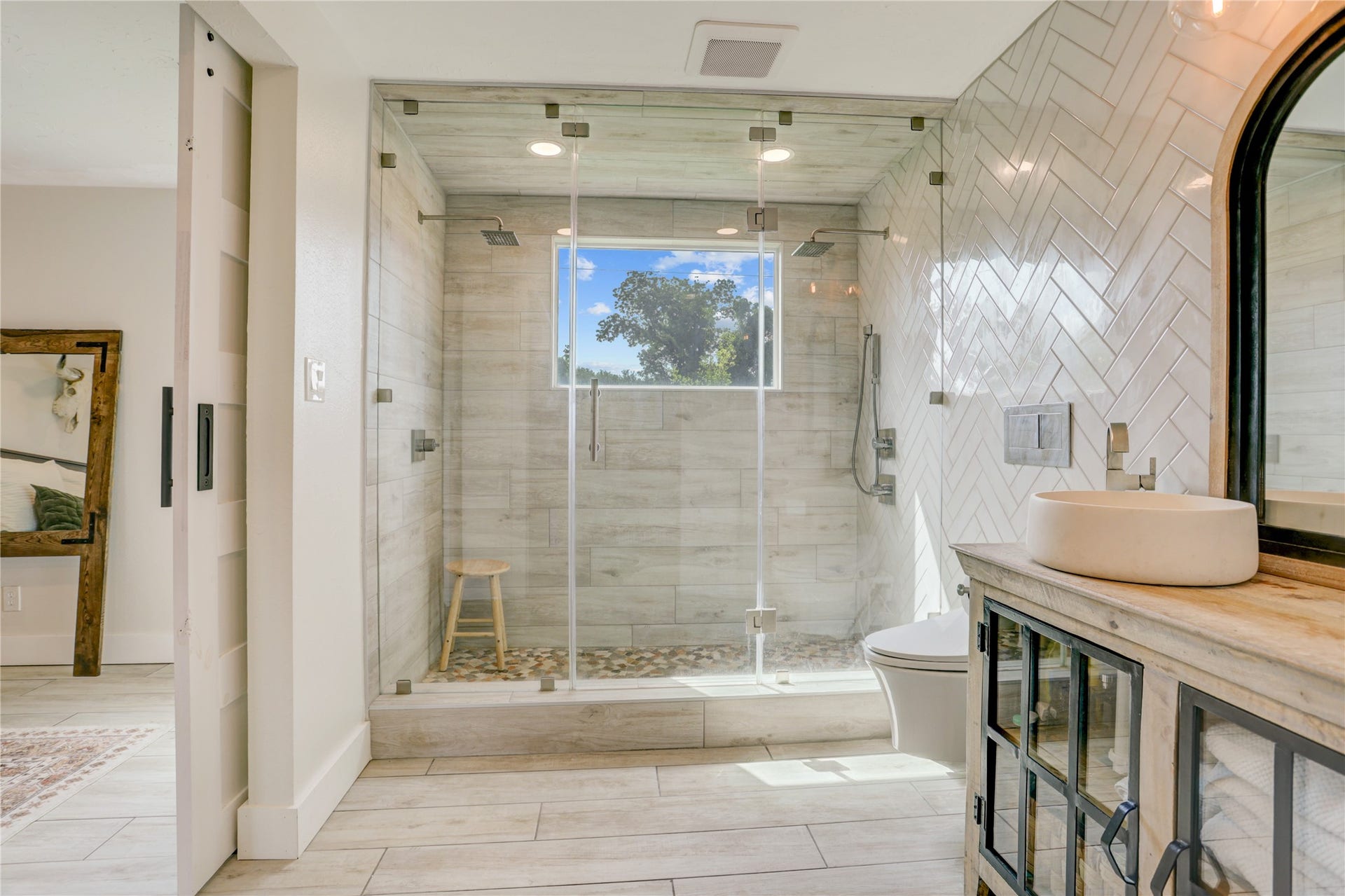 3311 Carmel Valley Drive, Missouri City, TX 77459 Custom bathroom includes a stunning walk in shower with dual rainfall showerheads, frameless glass enclosure, designer tilework, and a picture window that brings in natural light. What a way to start the day.