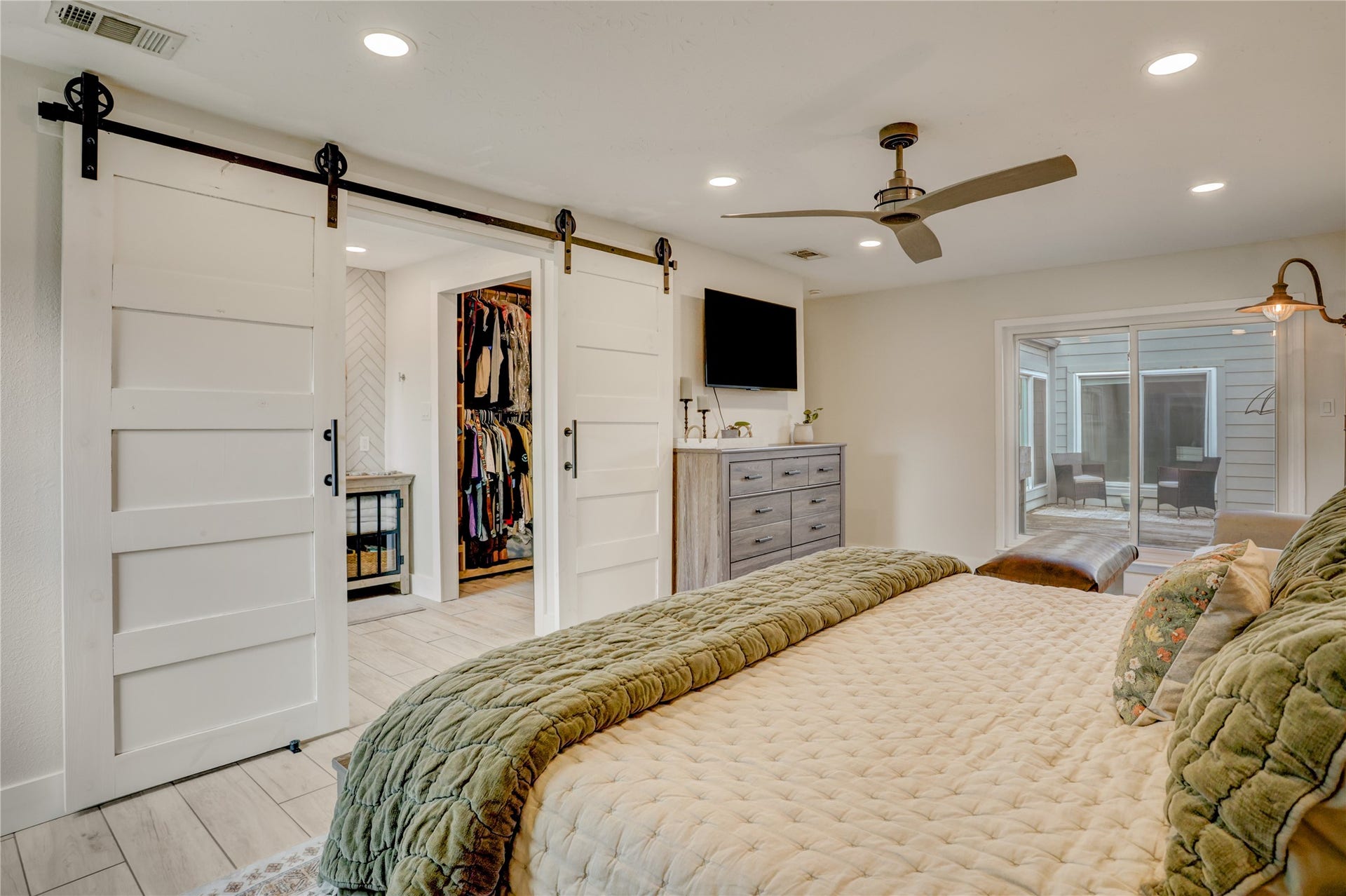3311 Carmel Valley Drive, Missouri City, TX 77459 Spacious primary suite featuring elegant barn doors lead the way to the generous walk in closet and spa inspired bath that creates a relaxing retreat.