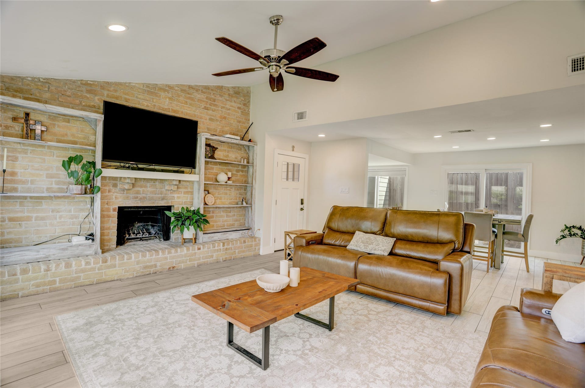3311 Carmel Valley Drive, Missouri City, TX 77459 Vaulted Ceilings, recessed lighting and the striking brick fireplace create a warm, versatile space for relaxing or entertaining.