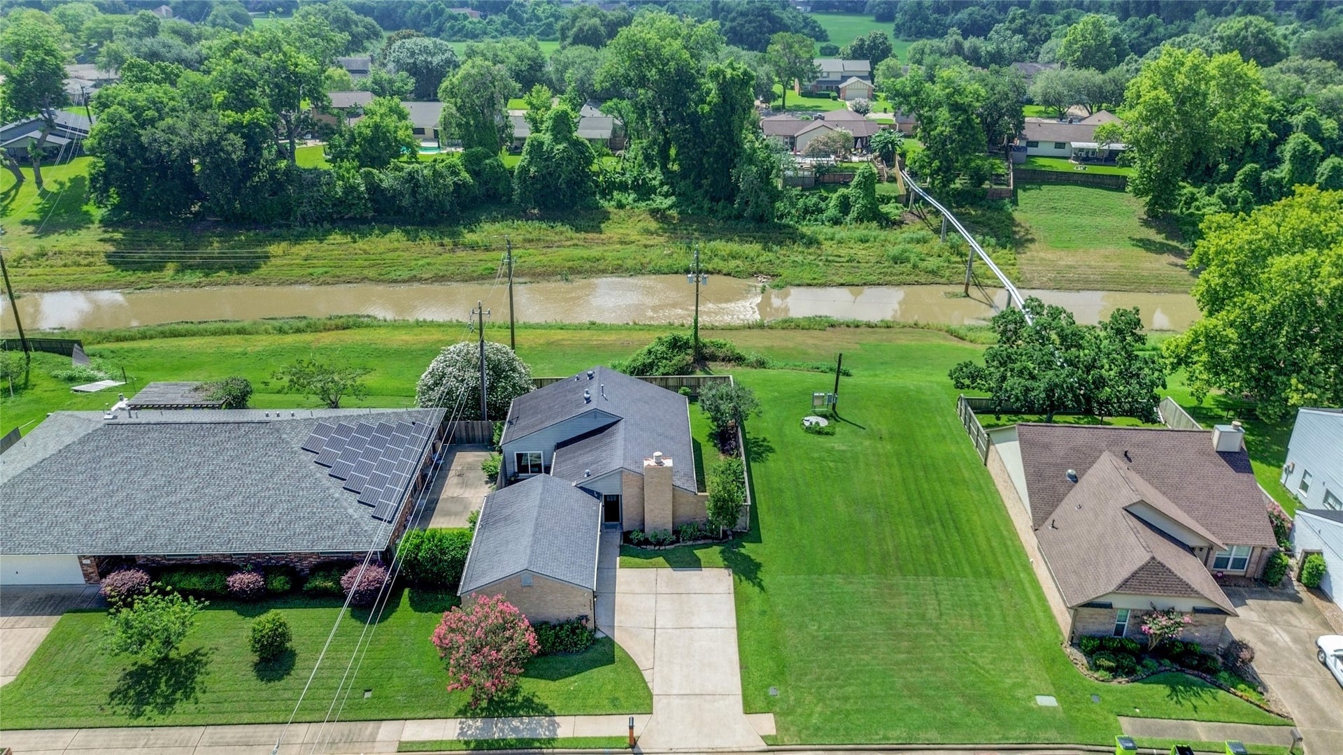 3311 Carmel Valley Drive, Missouri City, TX 77459 Aerial View showcasing the properties premier location with no back or side neighbors. The view of Oyster Creek is yours with the privacy of the country with the convenience of neighborhood amenities and major commuter routes still close at hand.