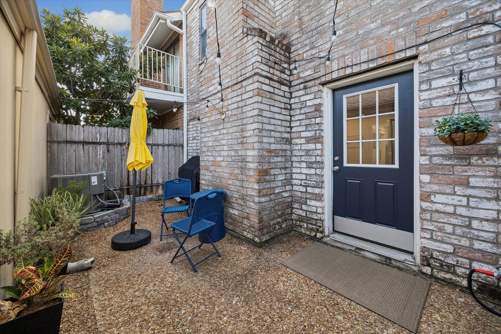 Back patio. The patio separates the house and two car garage.