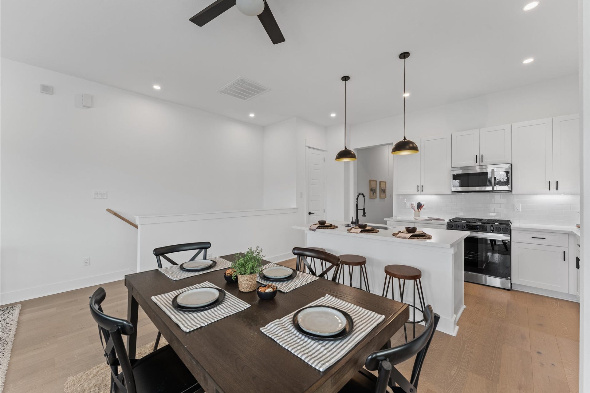 Elegant and inviting dining area designed for both everyday meals and special gatherings. The space features a well-proportioned layout that comfortably accommodates a full-size dining table, surrounded by stylish seating. Natural light filters in through nearby windows highlighting the rooms neutral palette and contemporary finishes.