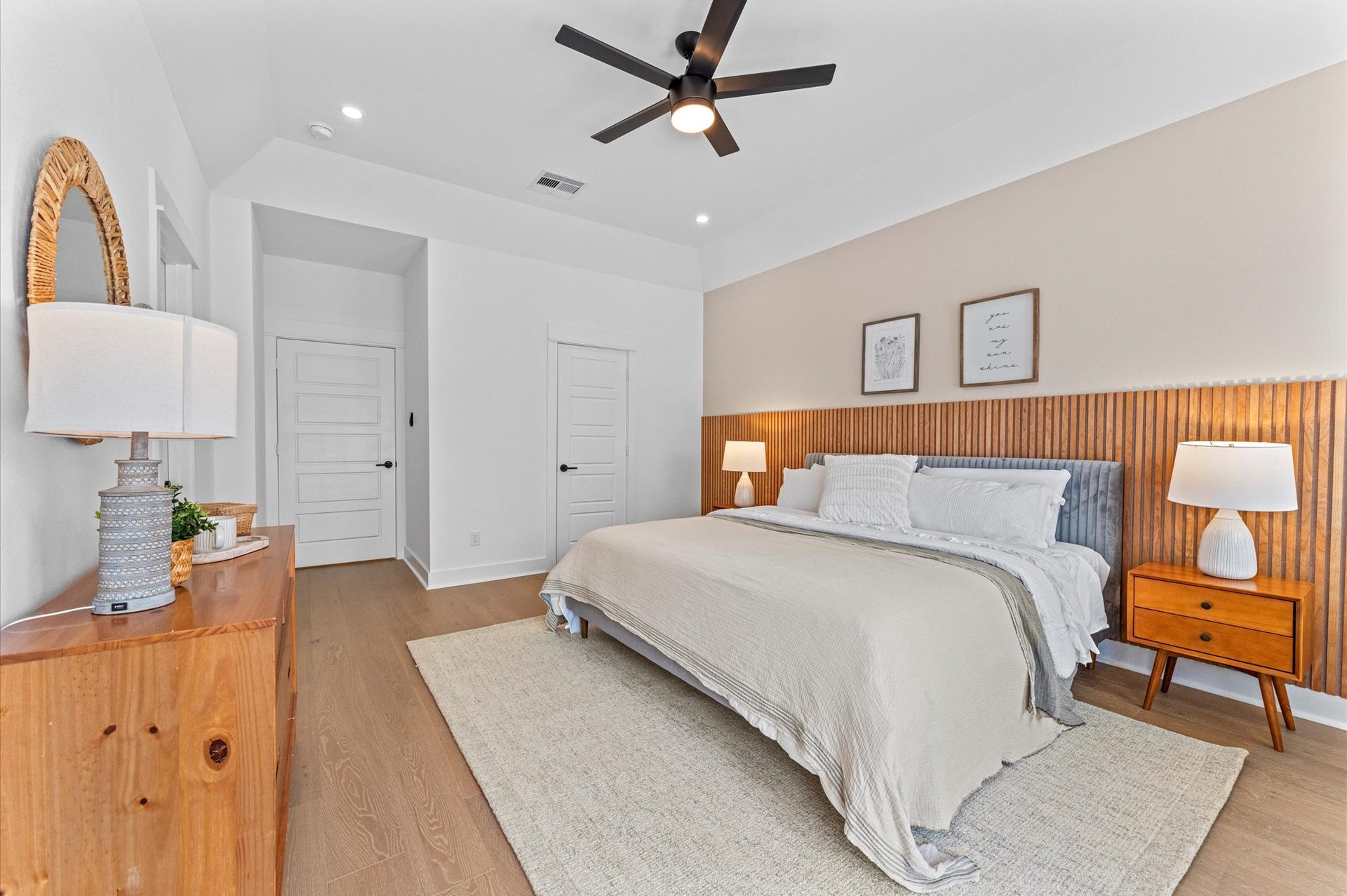 This spacious second-floor primary bedroom exudes modern elegance with its sleek engineered wood flooring that adds warmth and texture underfoot. High ceilings and big windows amplify the sense of openness, allowing natural light to cascade in and highlight the rooms charm. Whether styled with minimalist furnishings or layered with cozy accents, the space offers a serene retreat.