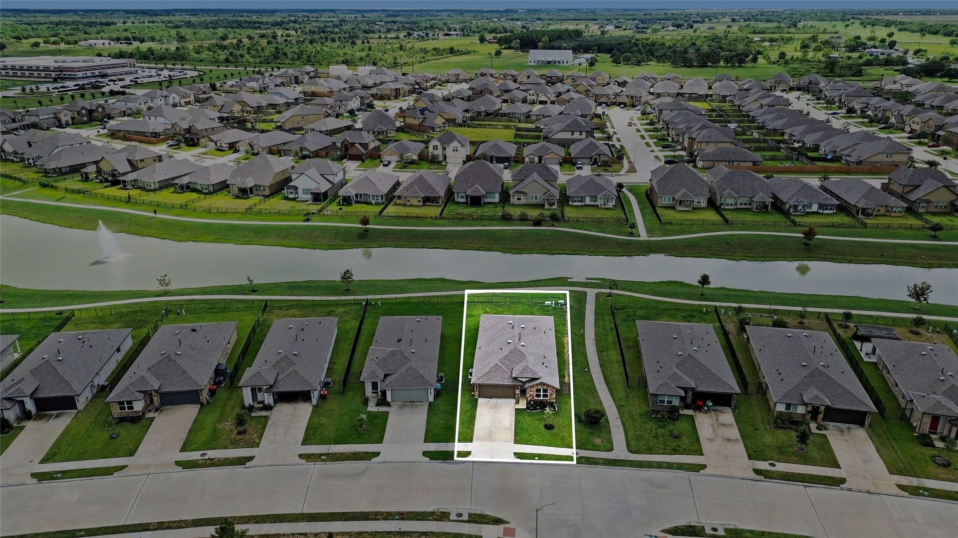 Beautiful lot with extra space on one side and a water view behind the home.  Gorgeous evenings on the back patio with fountain view, too!