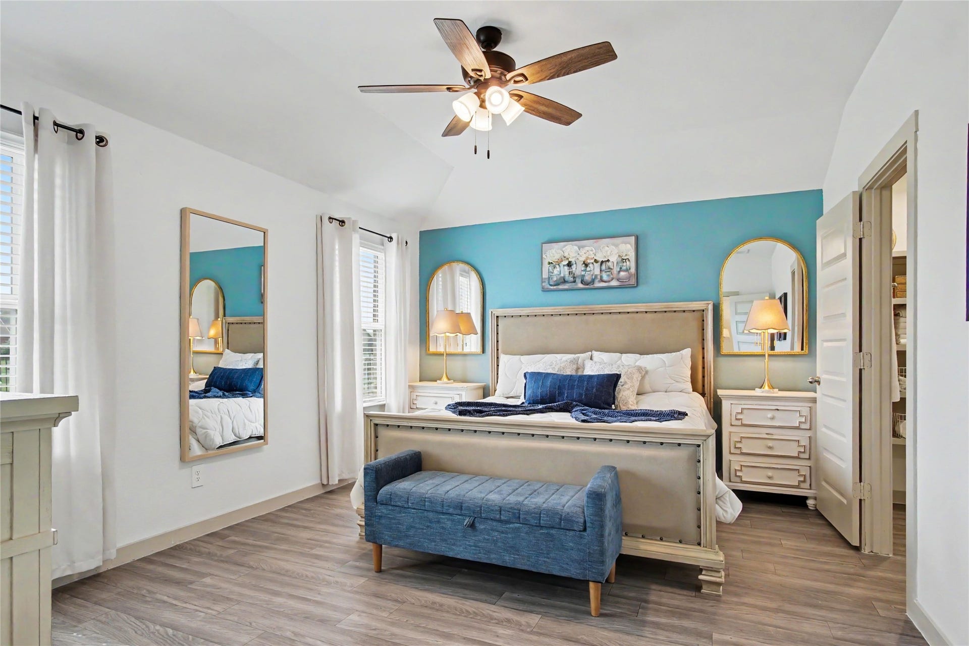 The spacious primary bedroom is at the back of the home.  The windows look out to the backyard.
