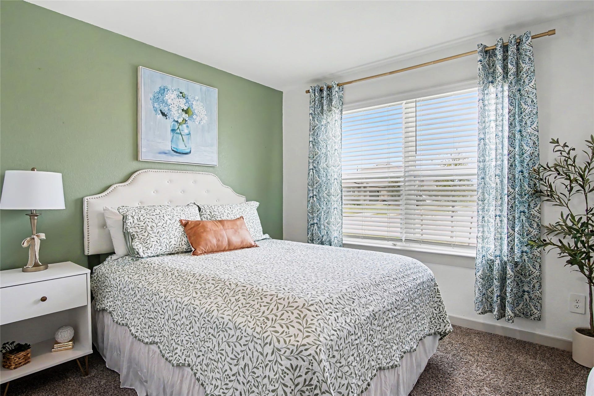 This tranquil bedroom (#2) with an accent wall is to your right after entering the home.  The window looks out into the front yard.