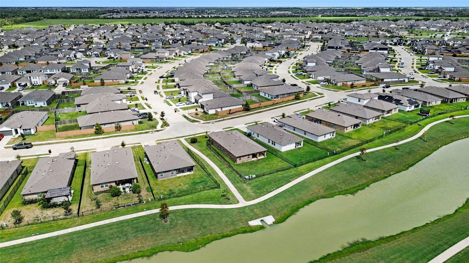 The path leading from the water to the street separates this home from the neighbors for extra privacy.  You can walk around the water by hopping on these paths!