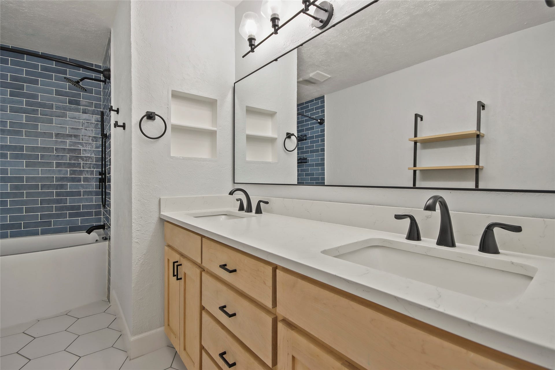 3527 Eula Morgan Road, Katy, TX 77493 This secondary bathroom features a tub/shower combo with blue subway tile and a quartz-topped dual vanity.