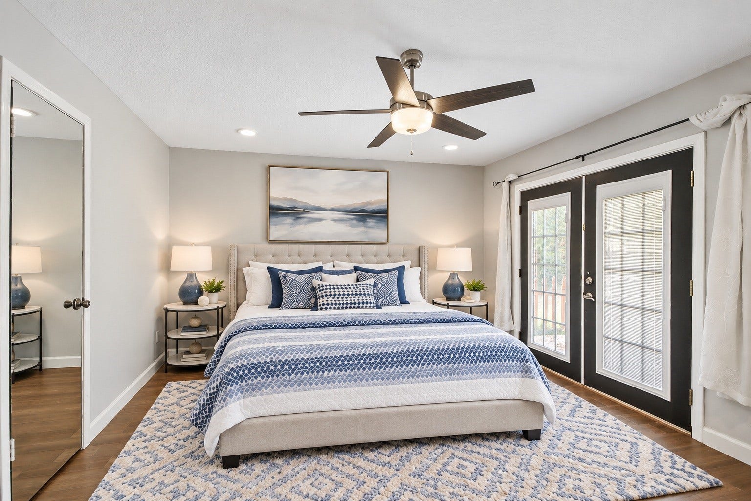 3527 Eula Morgan Road, Katy, TX 77493 The primary bedroom offers a spacious retreat with dark wood-look flooring, a ceiling fan, and French doors that bring in plenty of natural light. Virtually staged.