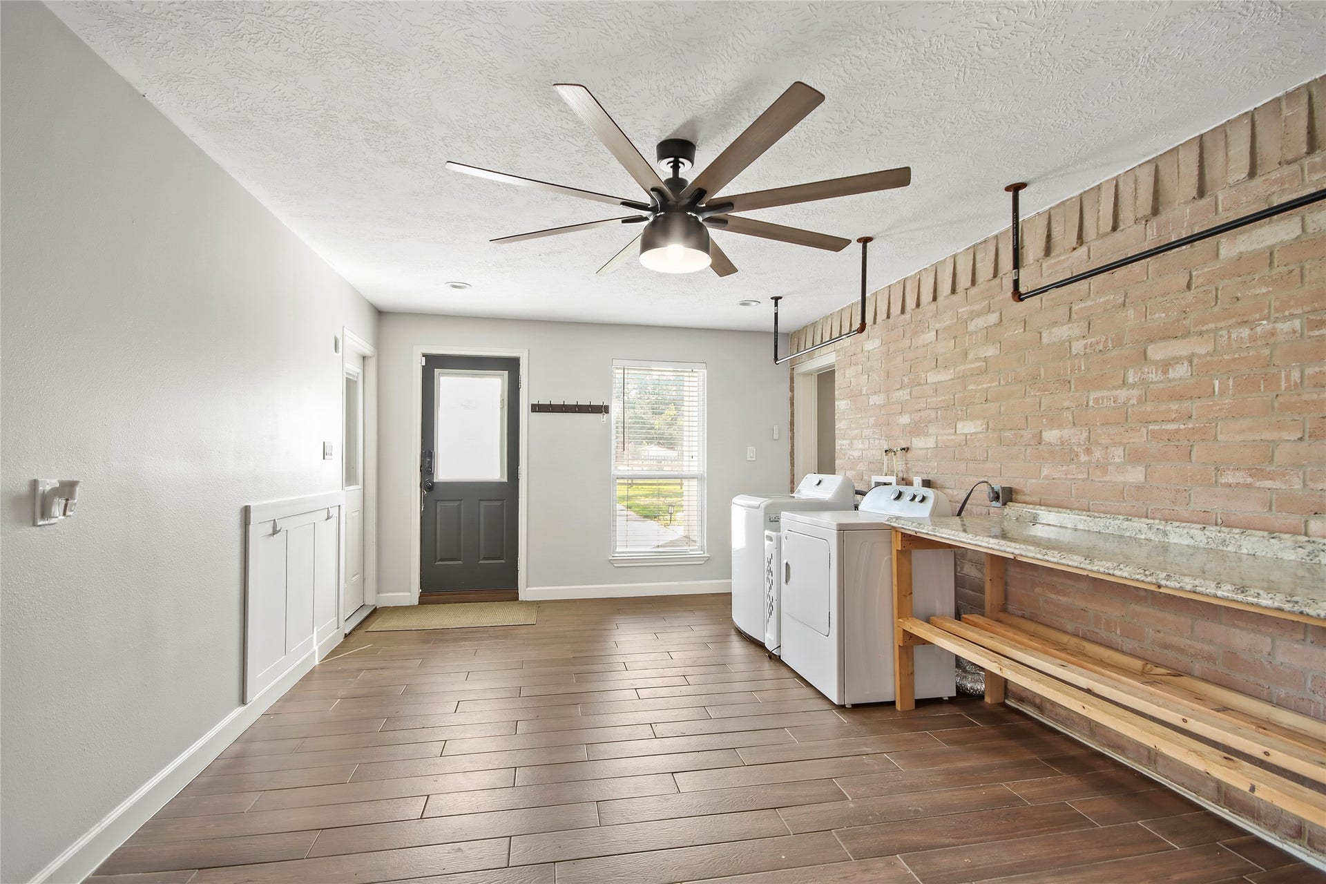3527 Eula Morgan Road, Katy, TX 77493 The spacious utility room offers room for a washer and dryer, plus a built-in folding counter and extra storage.