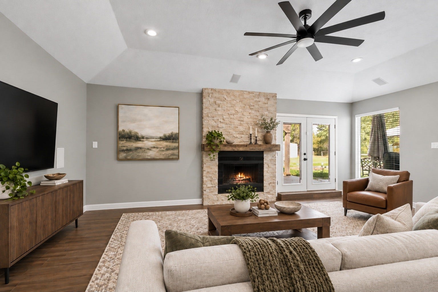 3527 Eula Morgan Road, Katy, TX 77493 The living area is anchored by a stunning stone fireplace with a wood mantel, framed by vaulted ceilings and French doors that bring in plenty of natural light. Virtually staged.
