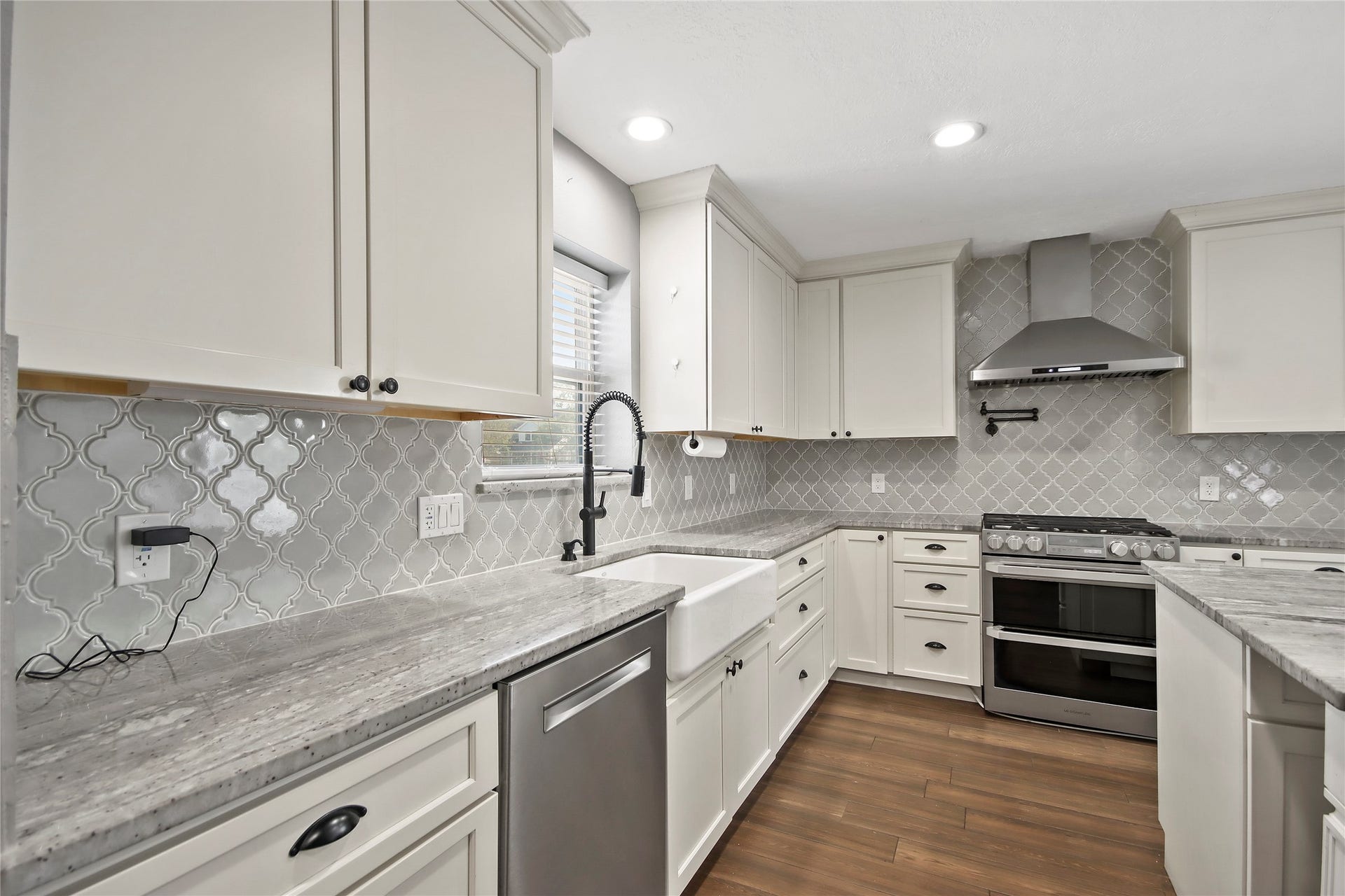 3527 Eula Morgan Road, Katy, TX 77493 Arabesque tile backsplash and crisp white cabinetry add a designer touch throughout the kitchen.