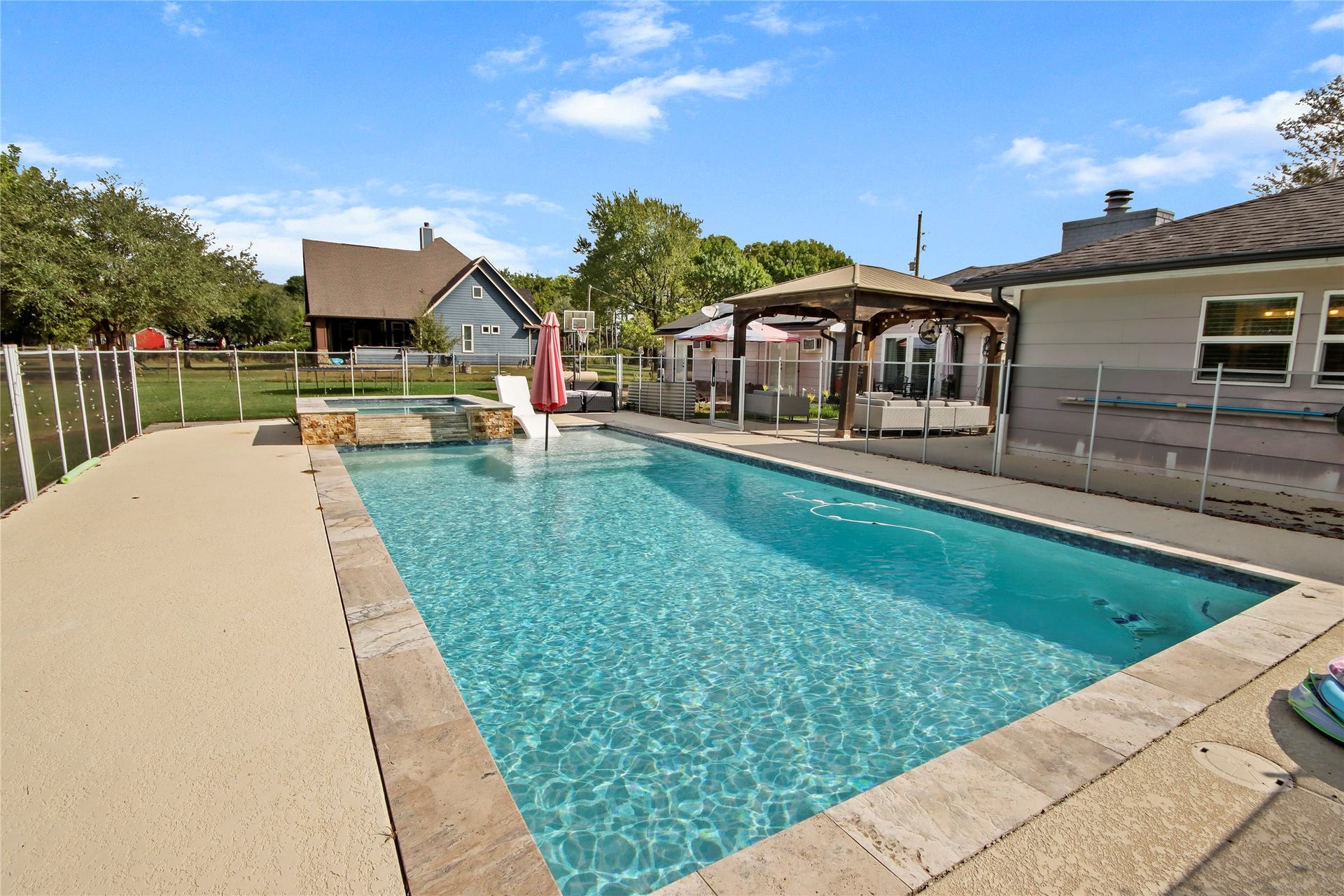3527 Eula Morgan Road, Katy, TX 77493 The sparkling pool is the backyard's centerpiece, complete with a raised spa, water features, and plenty of deck space for lounging.
