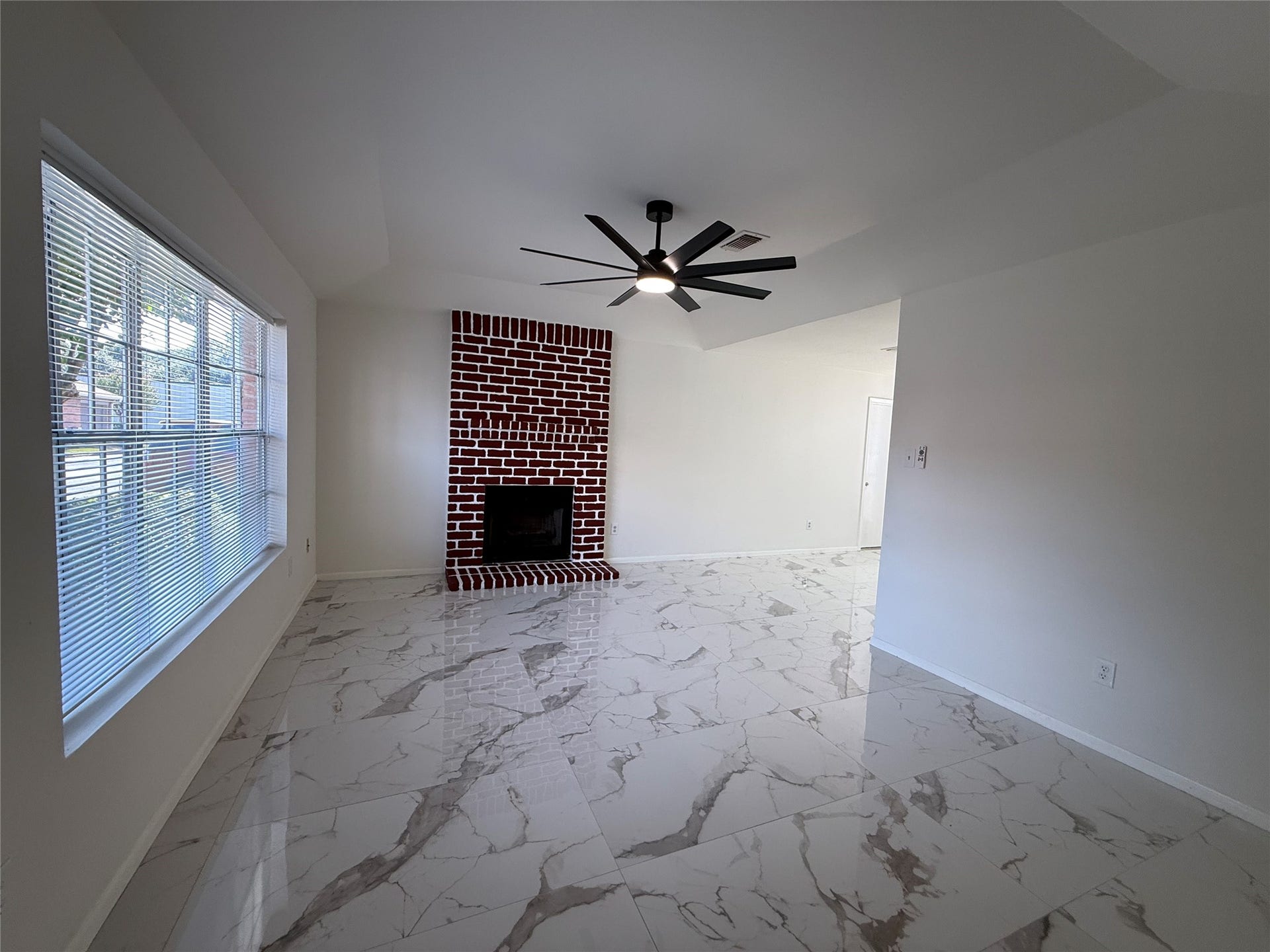 Living room with wood burning fireplace.