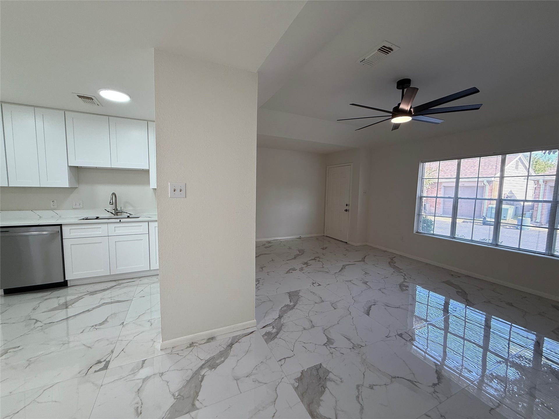 Open floor plan with quartz like tile floors.
